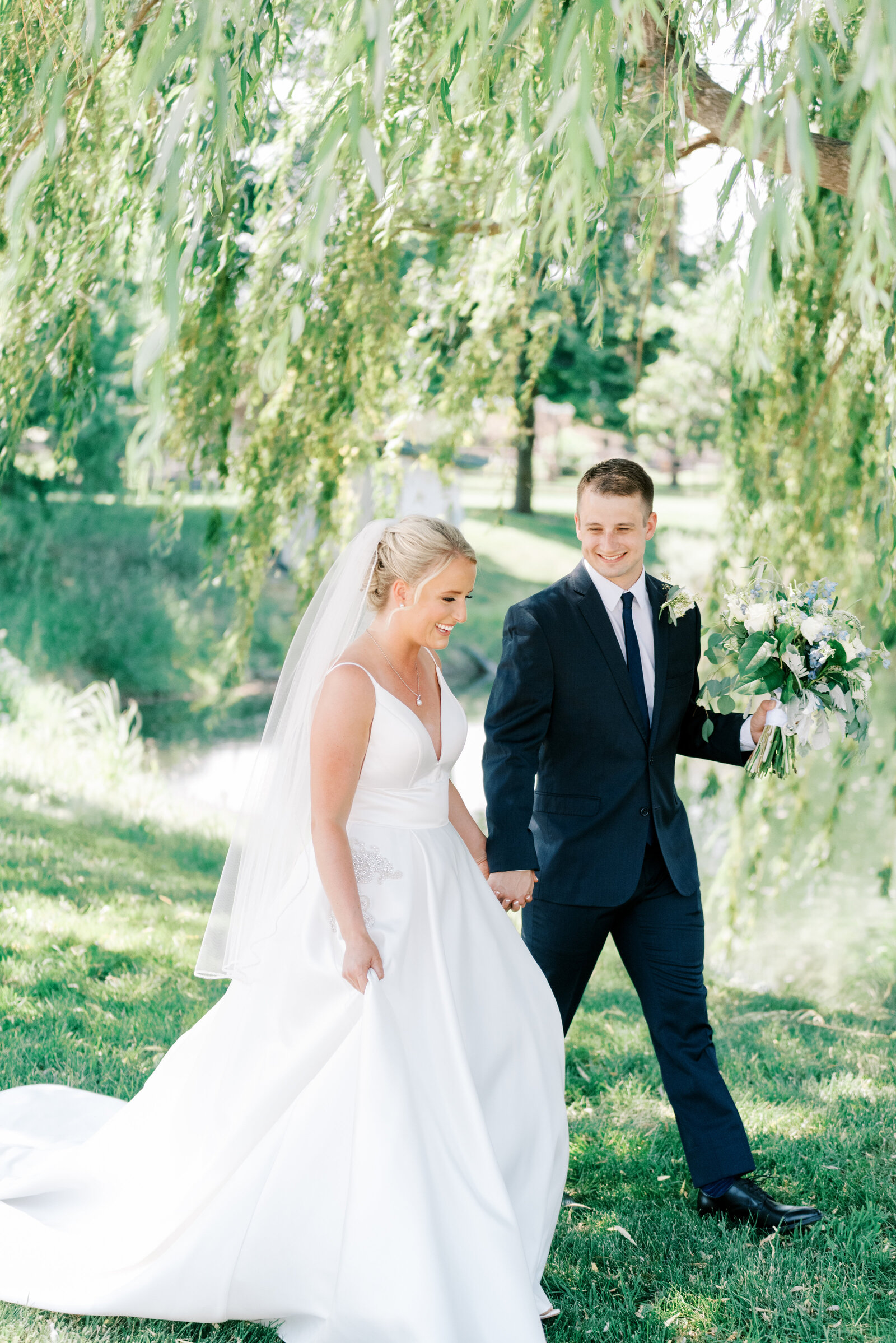 Bride and groom posing in willow trees at Honalee Farms, Boise wedding venue, captured by the Best Boise Wedding Photographers