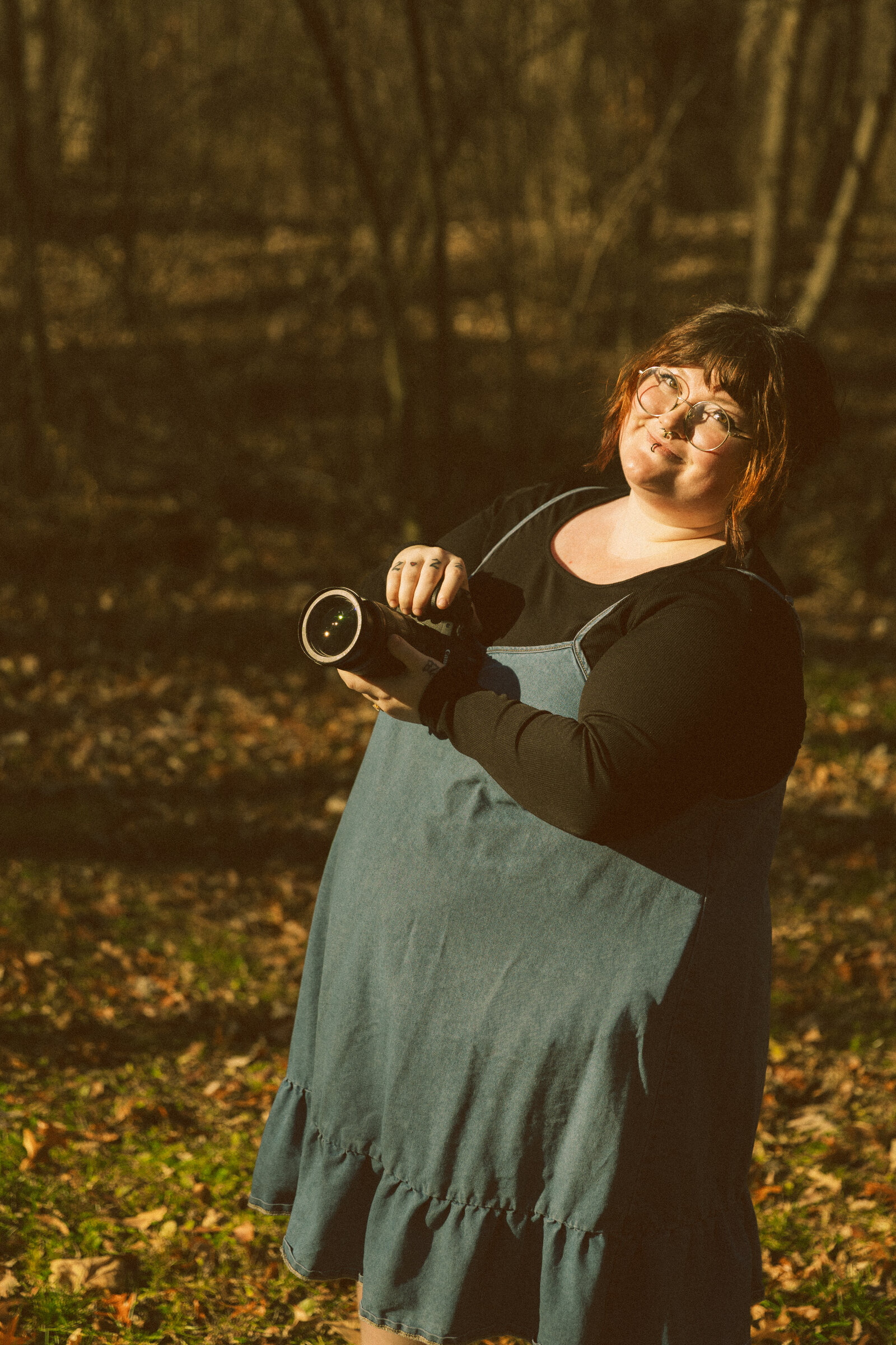 A groom carries his bride across the dancefloor under a twinkle-light lit tent while her veil flows and they smile
