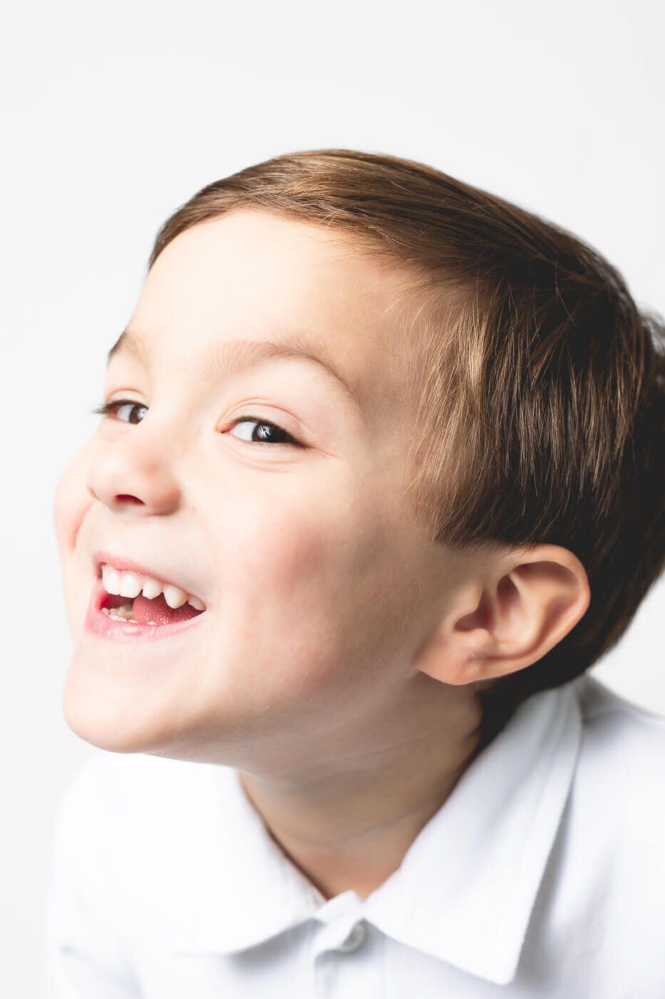 Side view of juvenile boy excitedly smiling