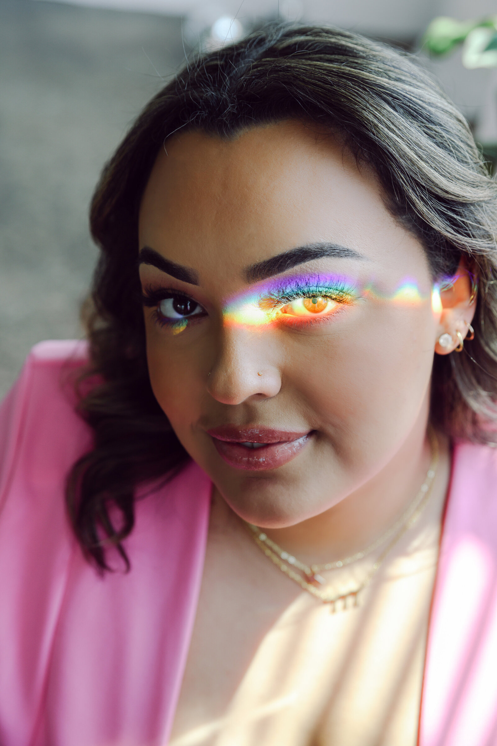 LGBTQ+ personal brand photography with rainbow prism in pink suit