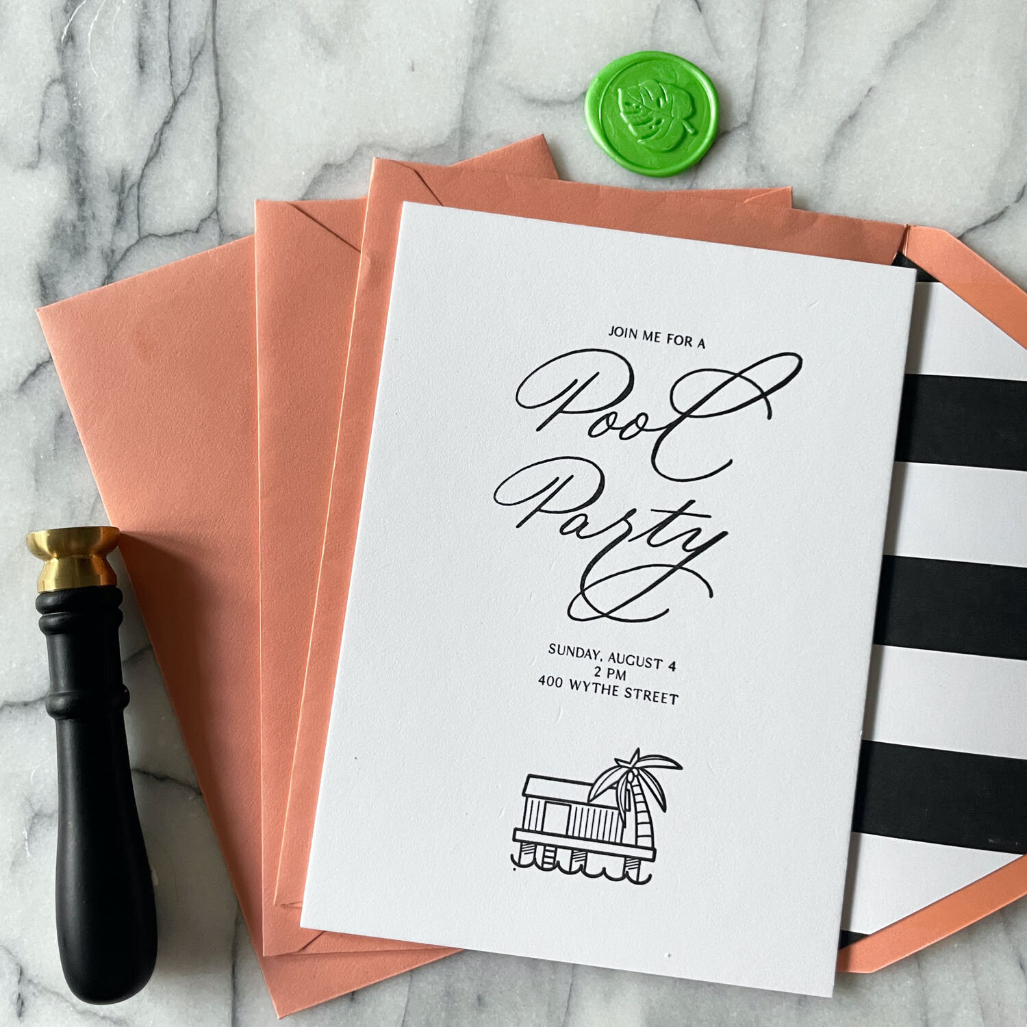 Pool party invitation with pink envelopes and wax seal.