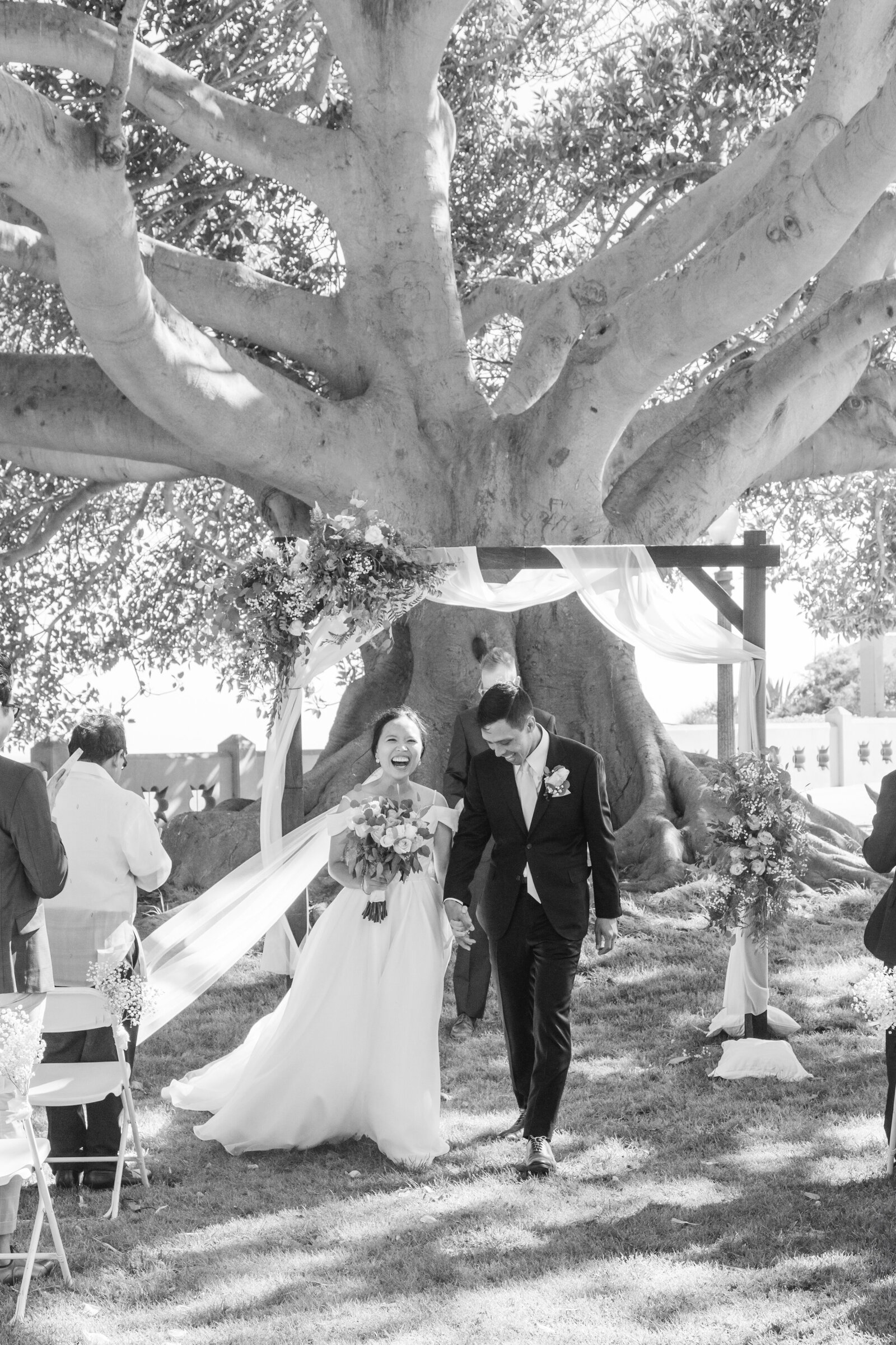 A newlywed couple holds hands after their wedding ceremony in San Pedro, Ca.