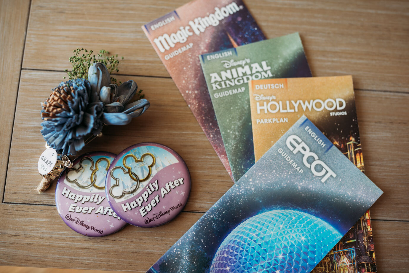 Disney park brochures and happily ever after pins pre-wedding details for Disney Springs Wedding