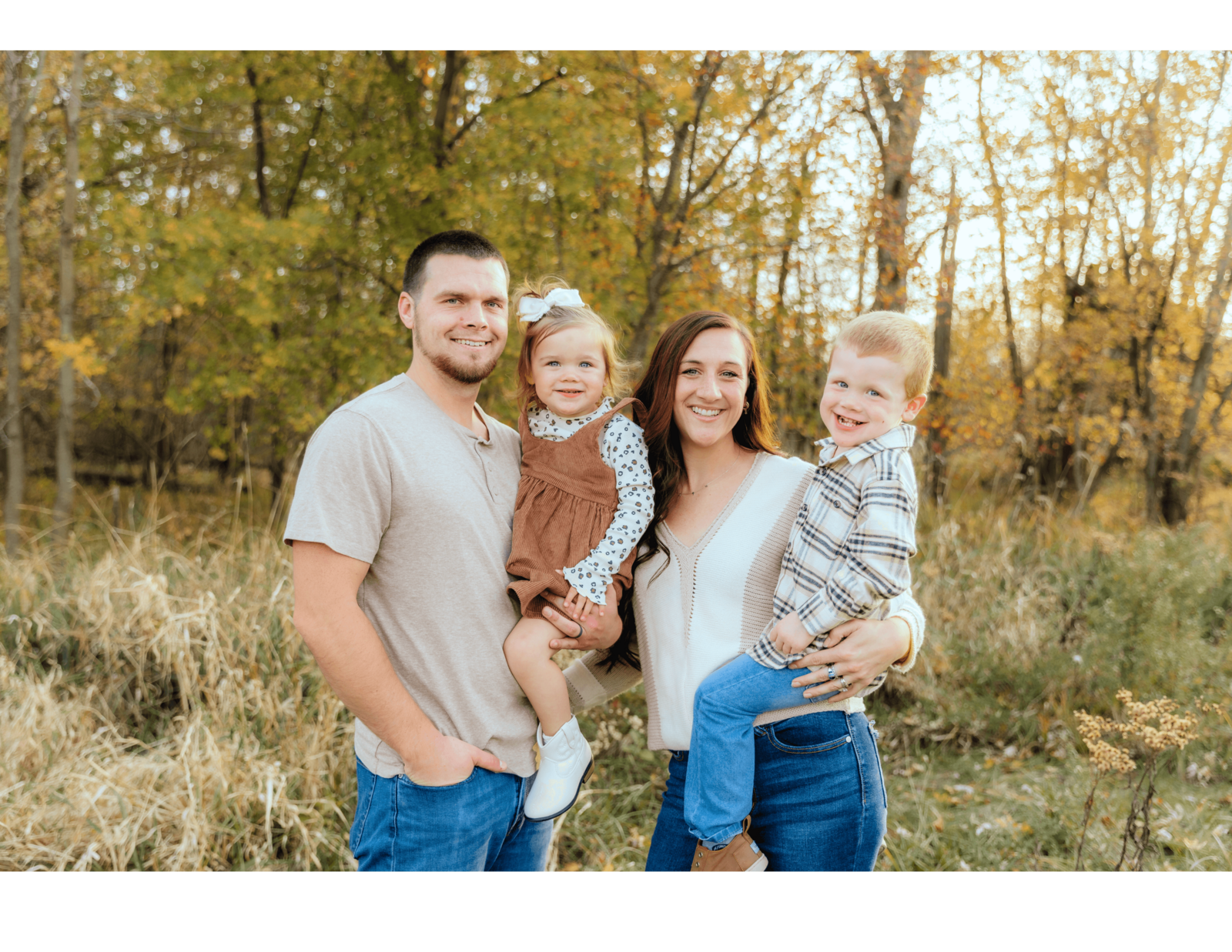 Warm and candid outdoor fall family photo with parents and two young kids in Michigan, captured by a lifestyle family photographer serving Michigan and Ohio.
