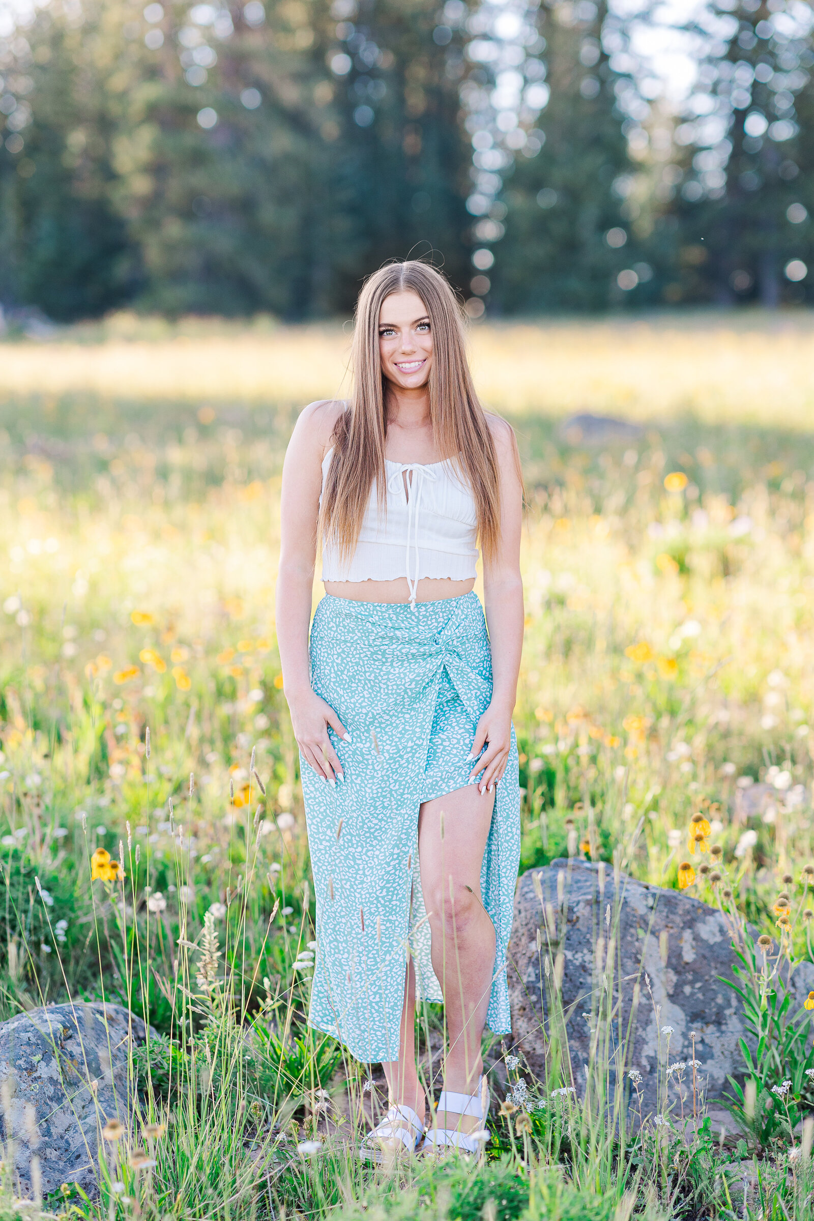 Wildflowers and field senior stands on the Grand Mesa