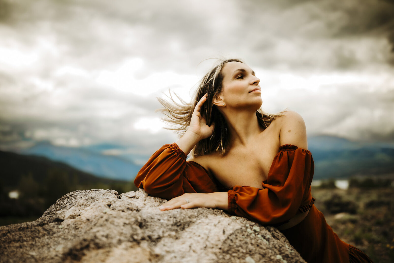 woman poses in the wind during a storm