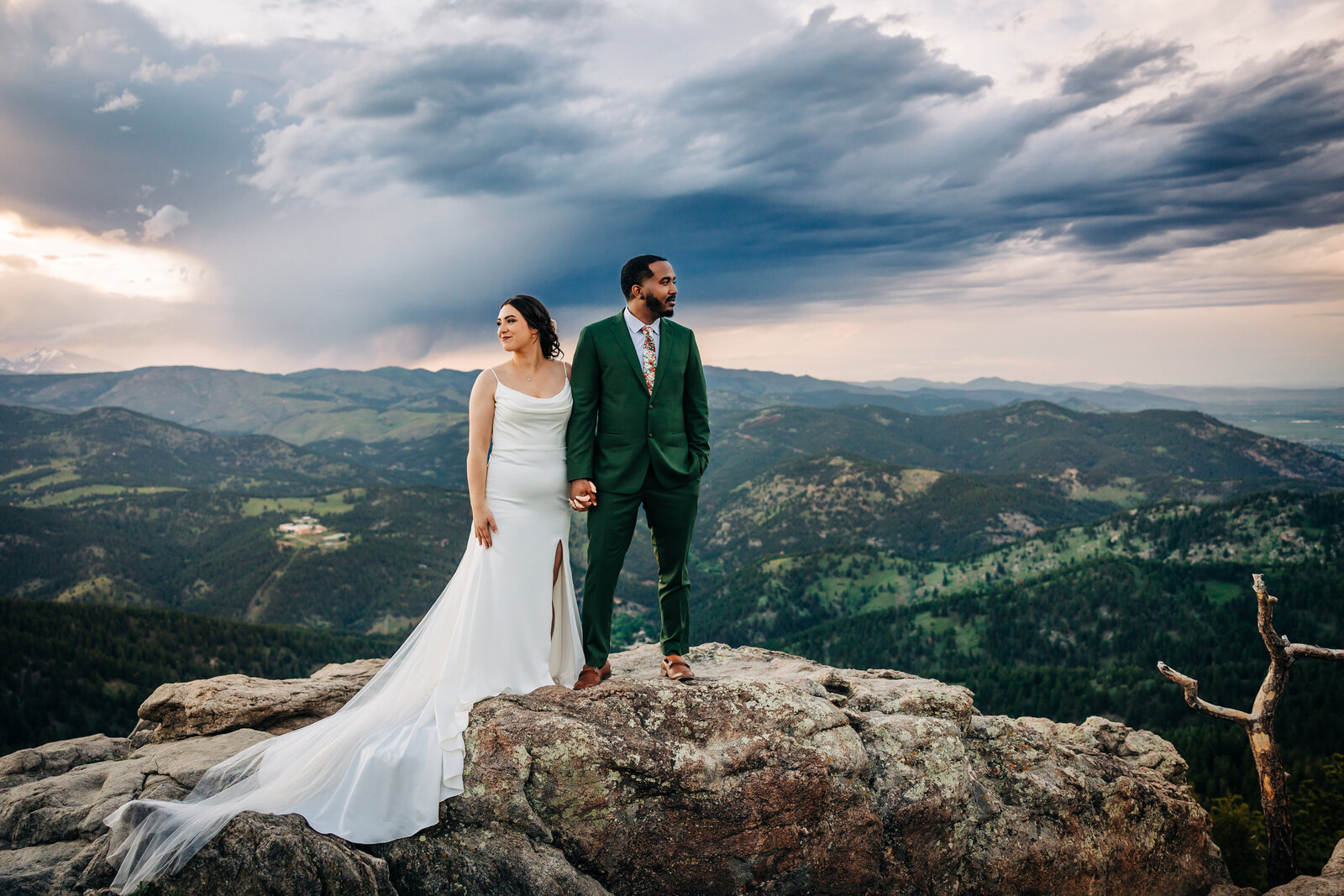 Wedding Photographer in Boulder Colorado captures bride and groom standing on rock after mountain elopement