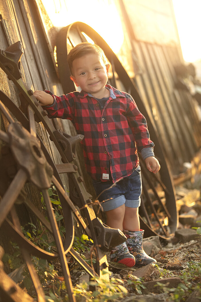 Boy playing at a farm in McKinney family photoshoot