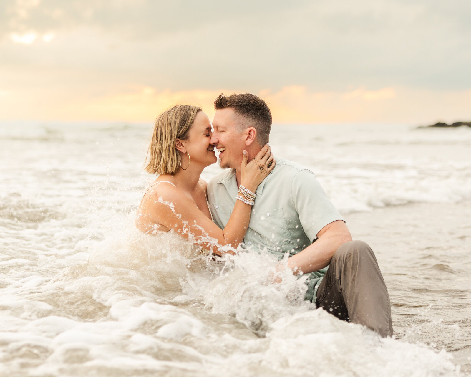 an almost kiss in the crashing waves of the beach