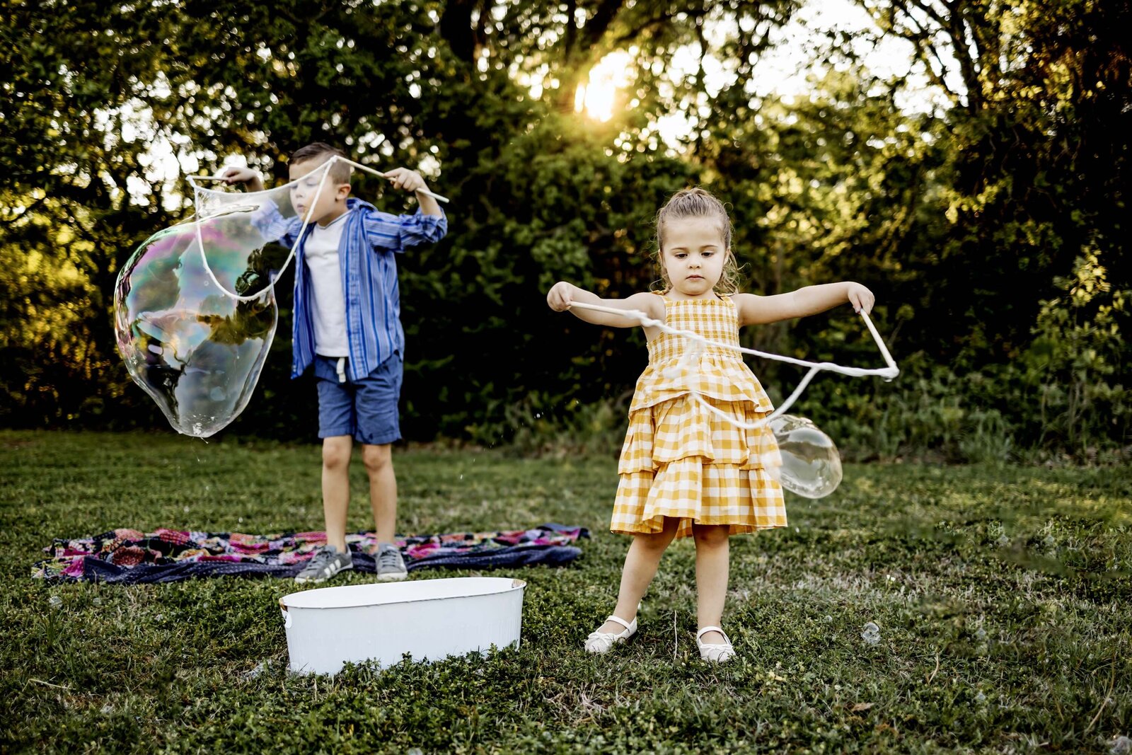 two kids playing with giant bubbles in the park in Southlake texas