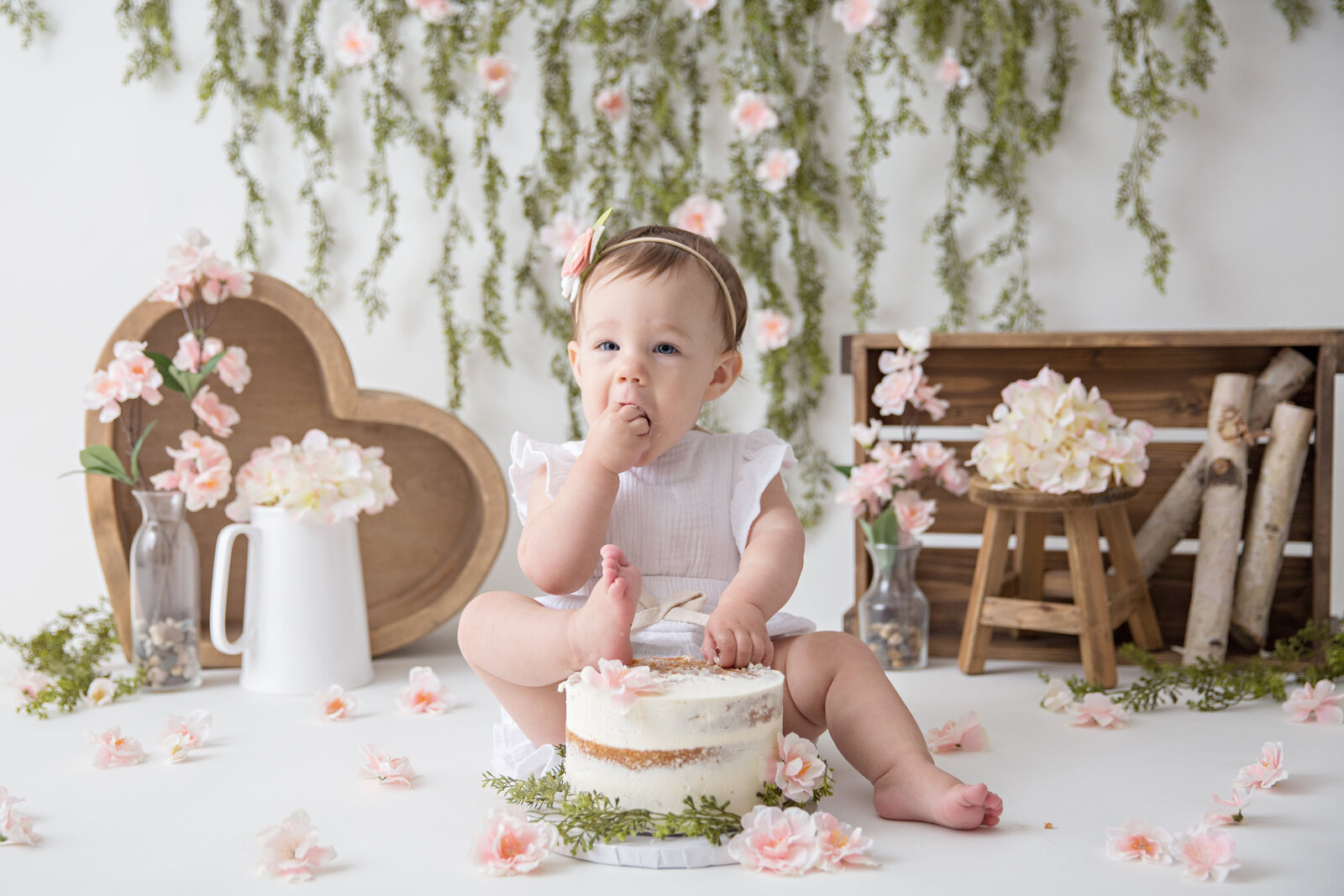 baby girl boho floral cake smash foot in cake