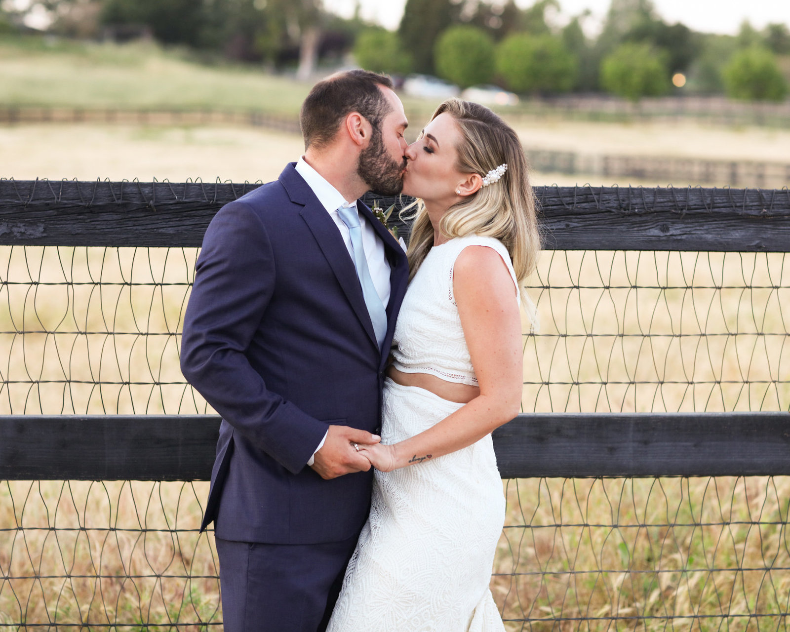 Bride and groom kiss, beautiful wedding in a rustic setting