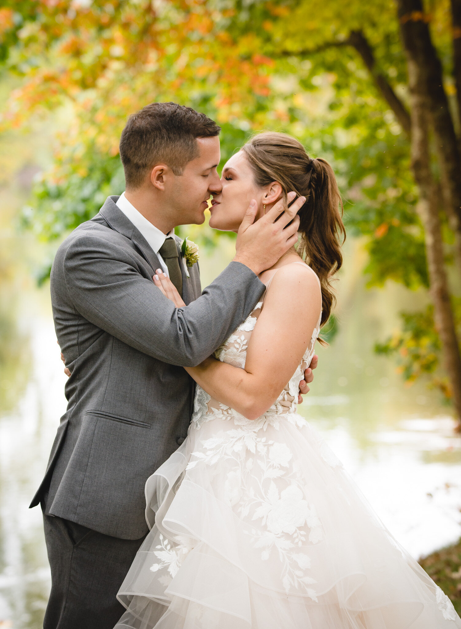wedding couple kissing in New England fall foliage