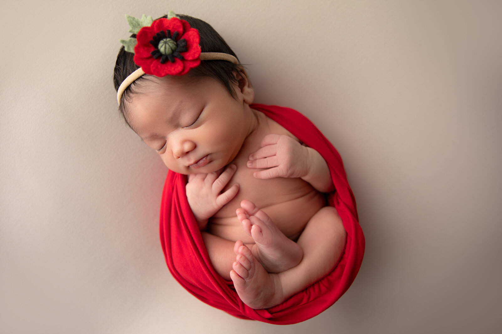 A delicate close-up of a sleeping newborn, showcasing their tiny fingers and peaceful expression. Perfectly captured in our Phoenix studio, this photo highlights the innocence of your baby’s first days.
