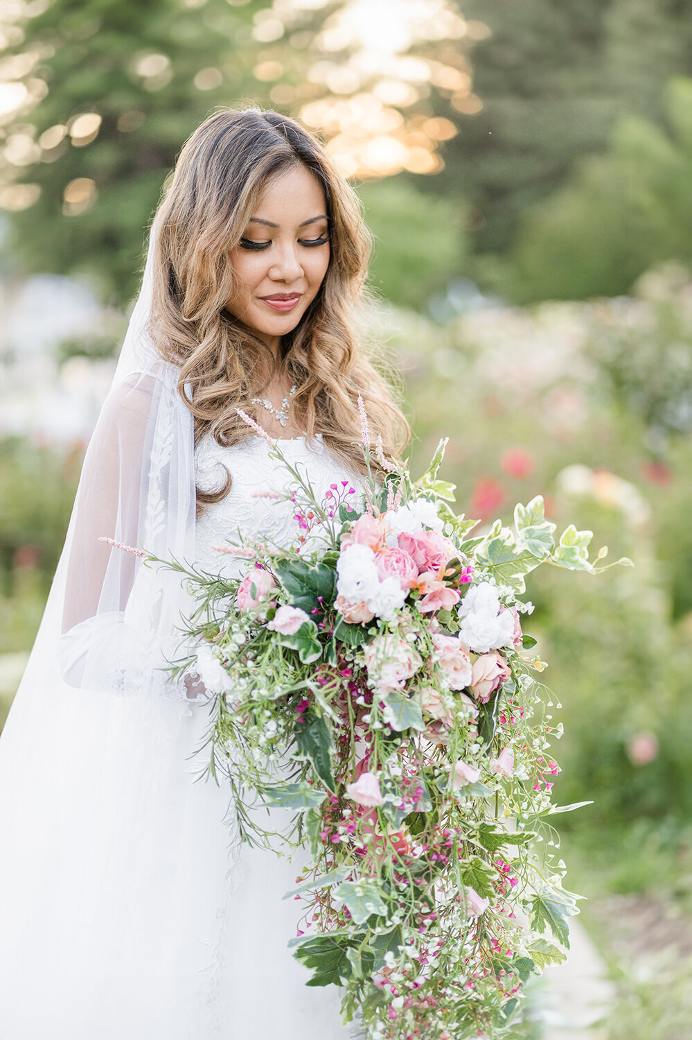 a bride poses for portraits at her mckinley rose garden wedding in downtown sacramento california by adrienne and dani photography
