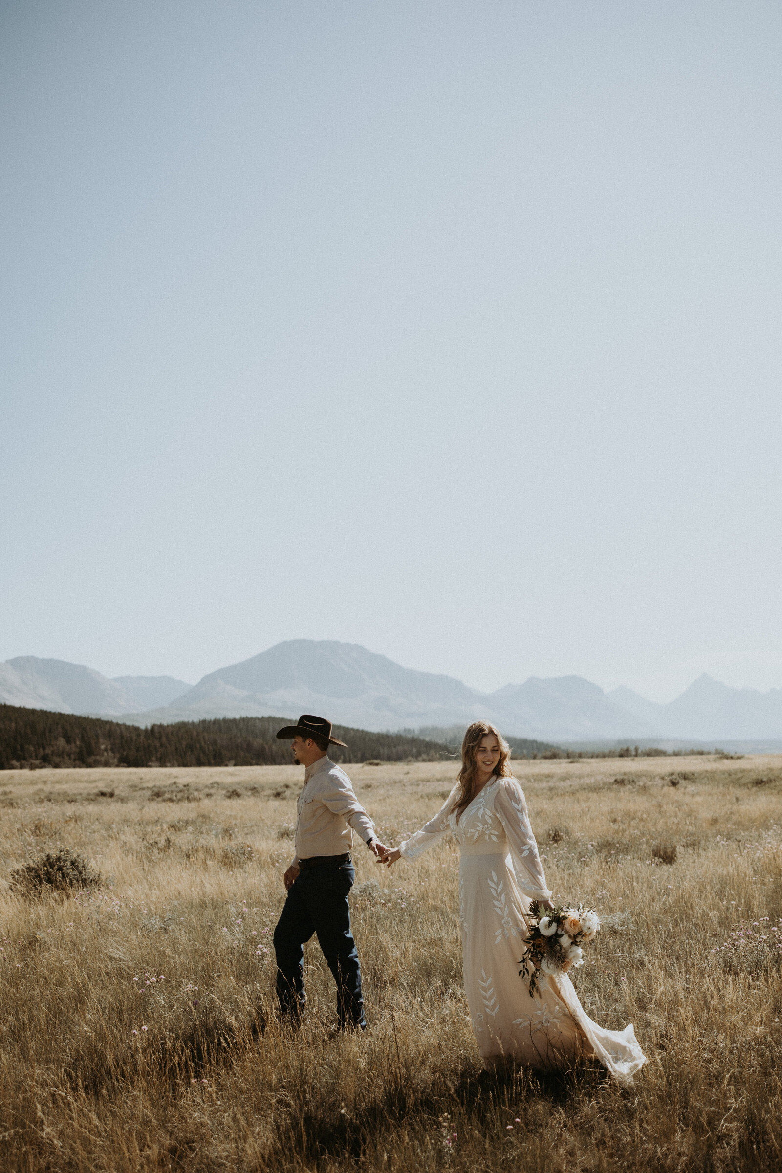 couple walking holding hands in montana during their elopement 