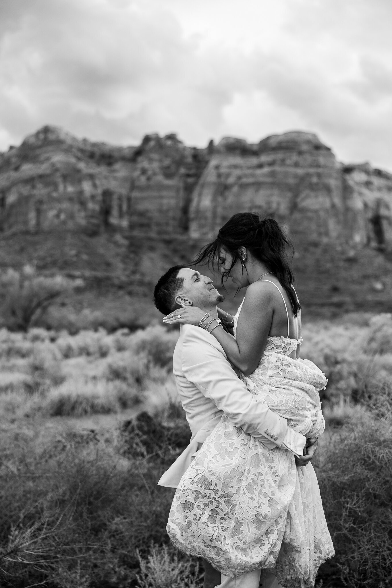 Beautiful sweet moment captured as bride and groom kiss in front of the utah mountains on wedding day 