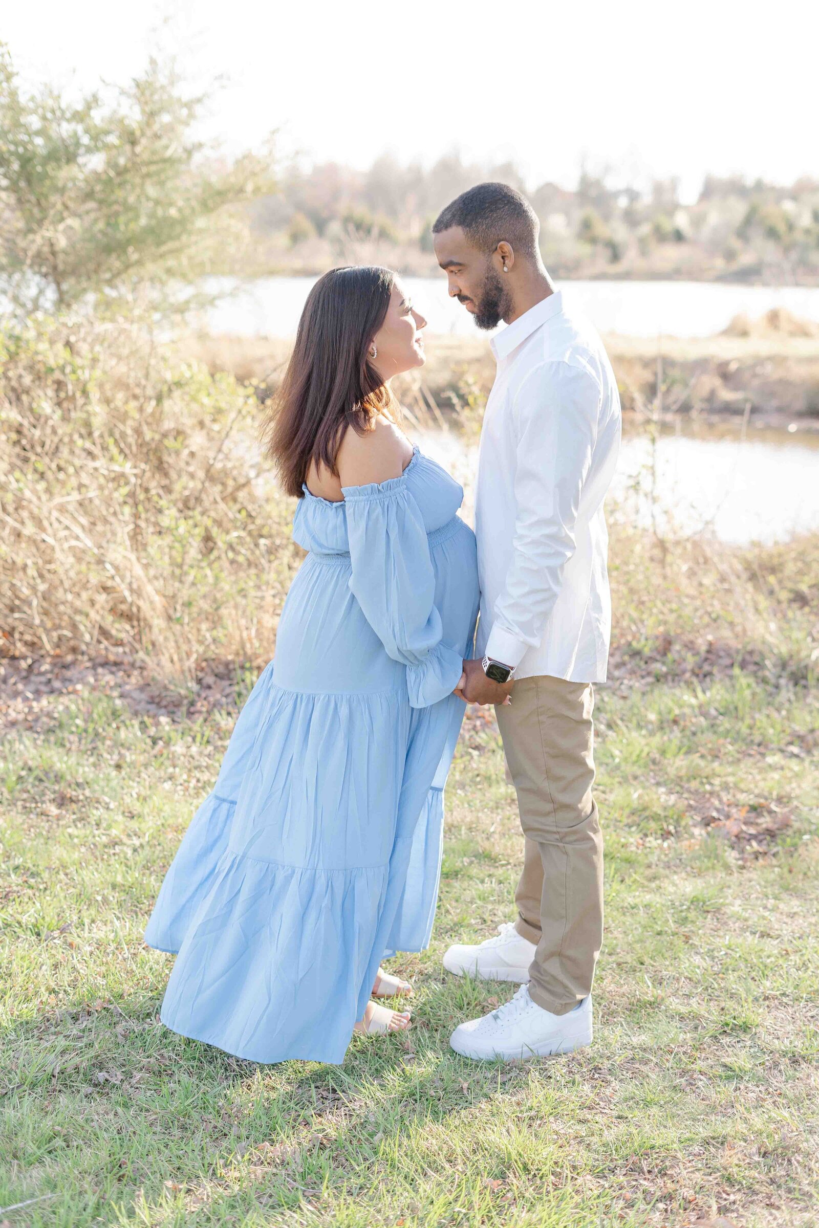expecting parents looking at each other in Sterling, VA
