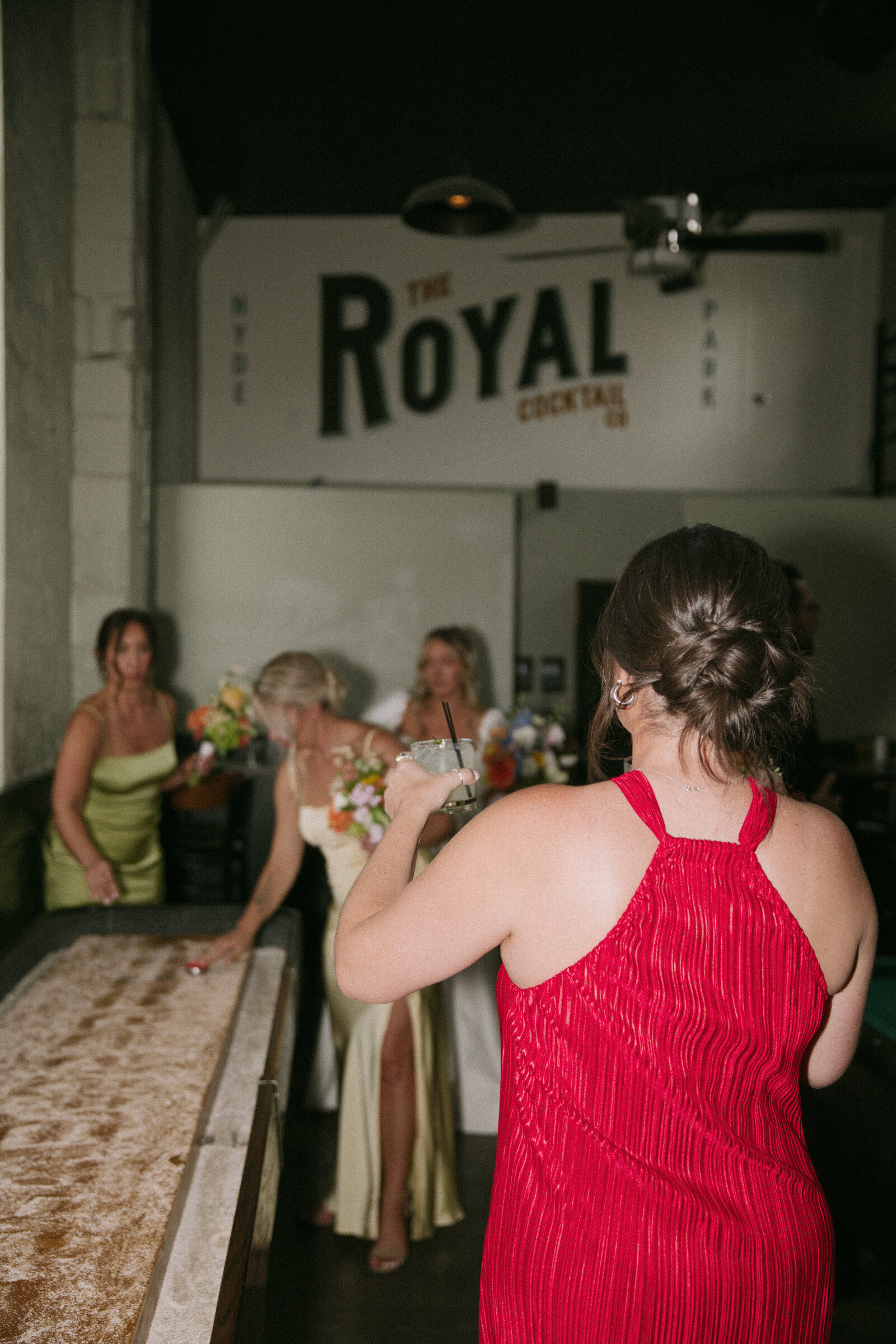 Bridesmaid shares a cocktail with bride at TRICA wedding in Boise