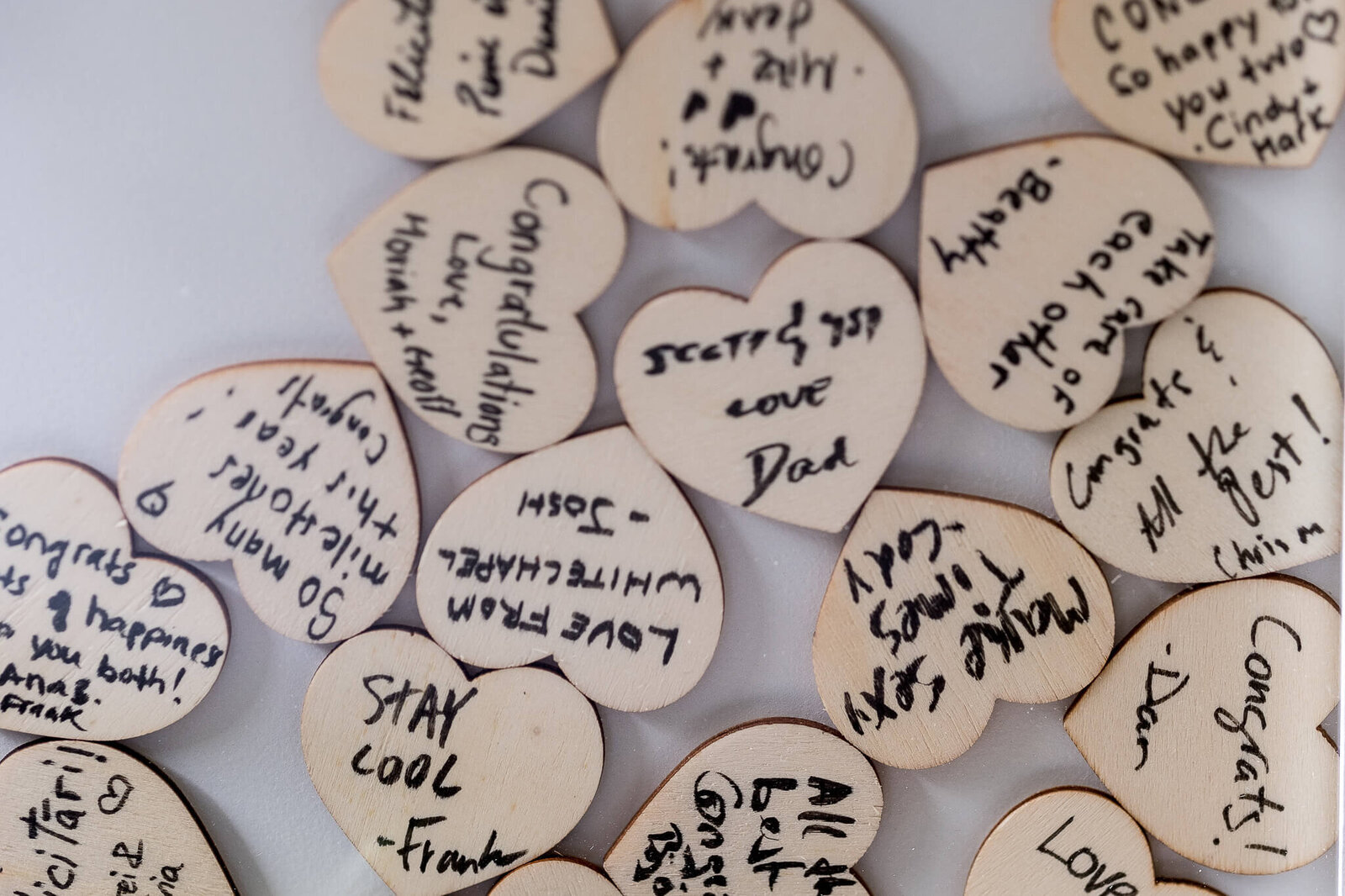Wooden hearts with messages from wedding guests.
