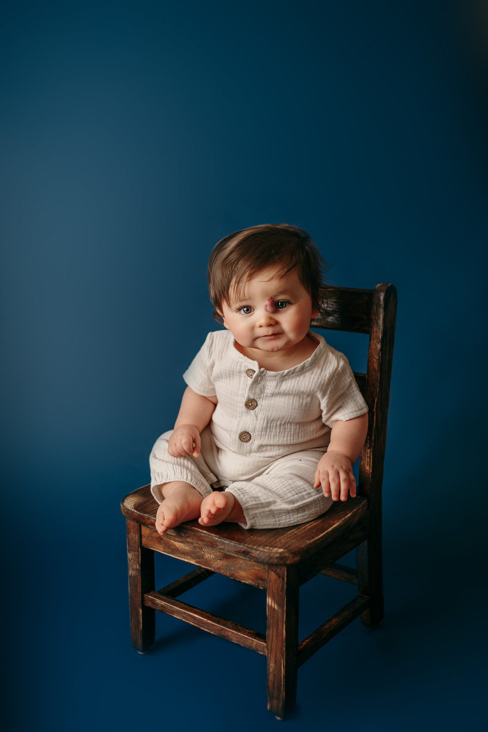1 year old boy on chair during photoshoot in Tampa