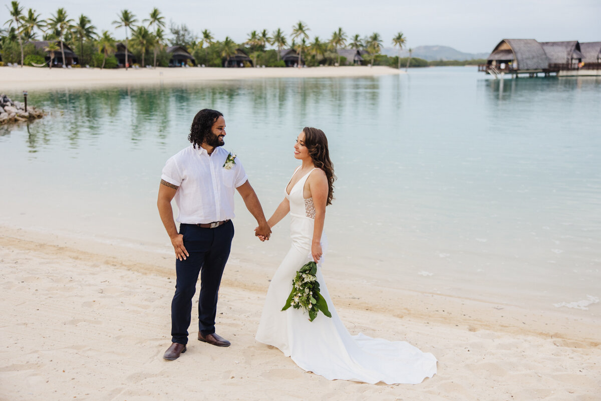 couple on beach holding hands