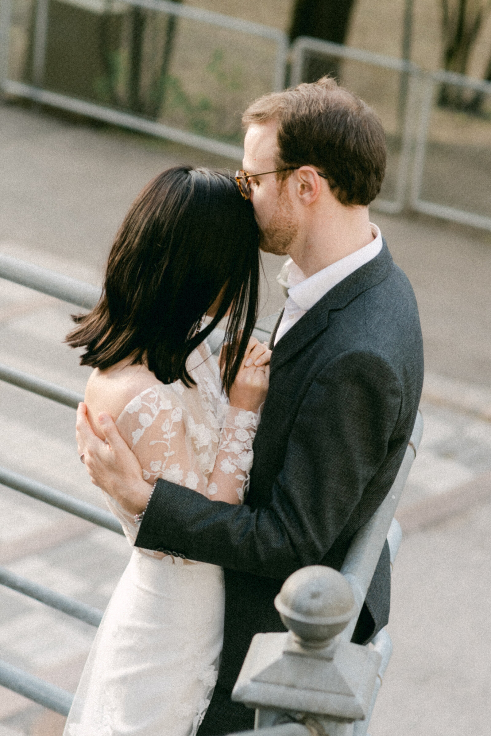Bride and groom hugging in  a romantic image photographed on the streets of Helsinki by the Finnish wedding photographer Hannika Gabrielsson.