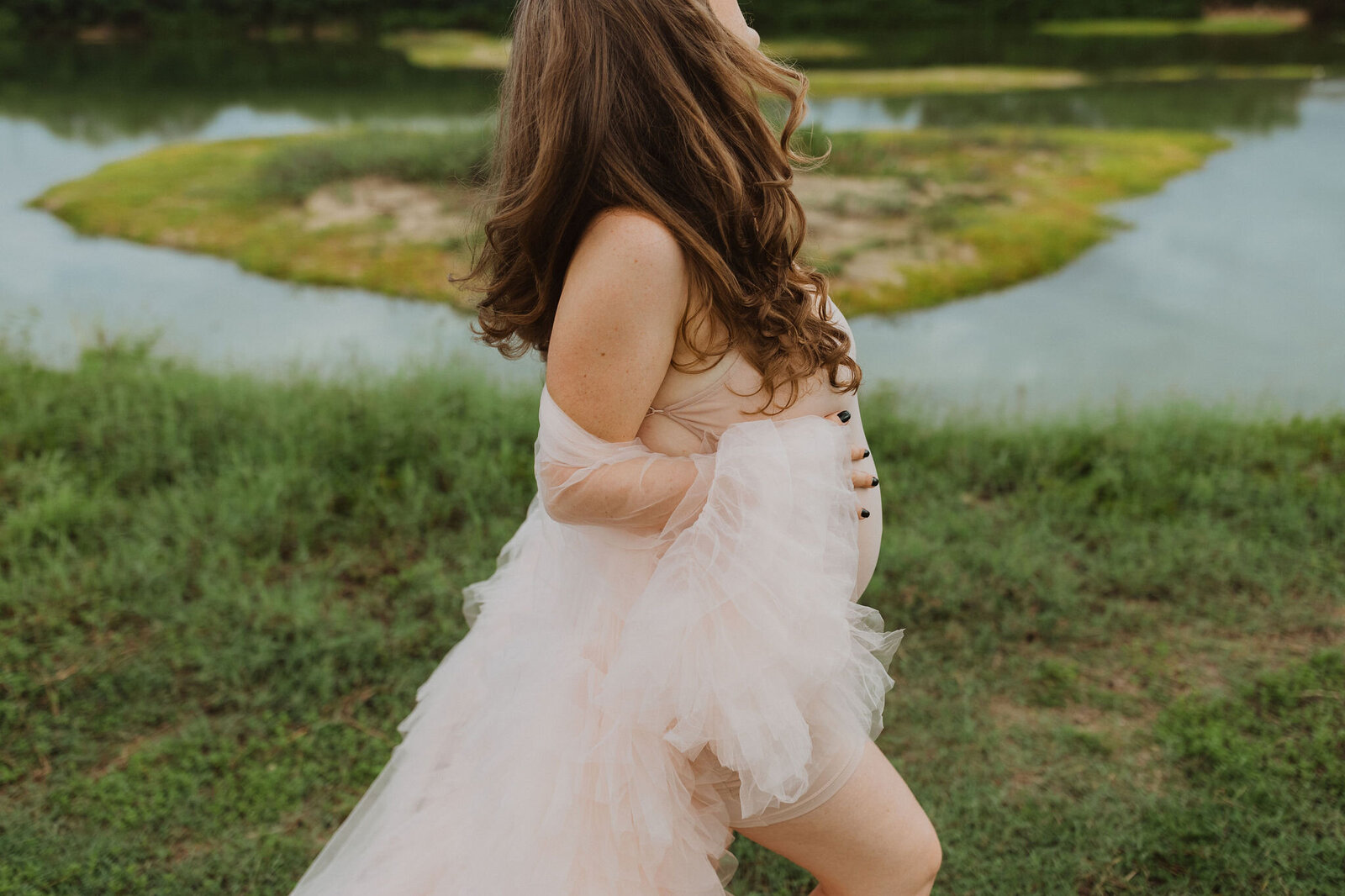 Pregnant woman walking and holding her belly