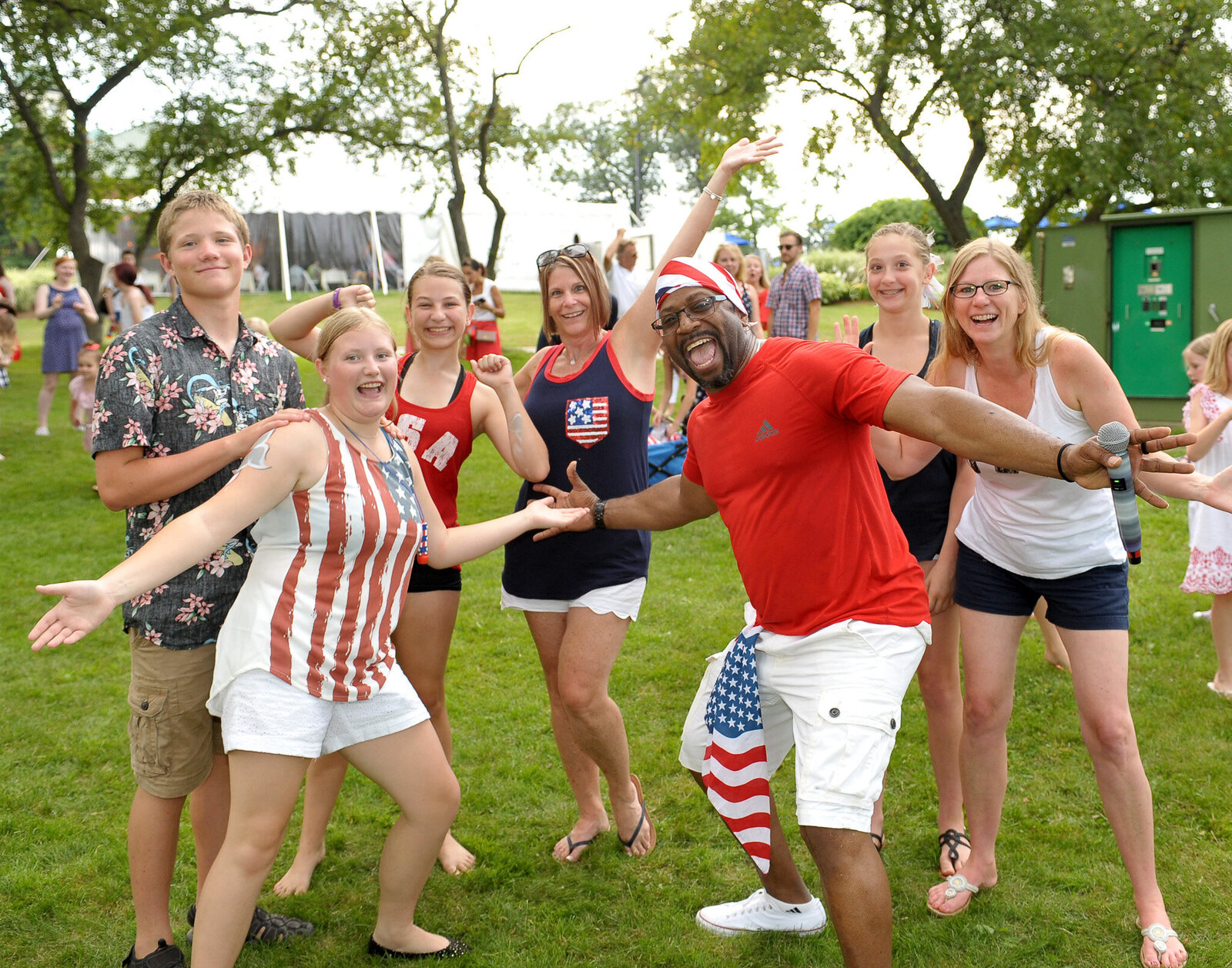Group in patriotic outfits posing on grass