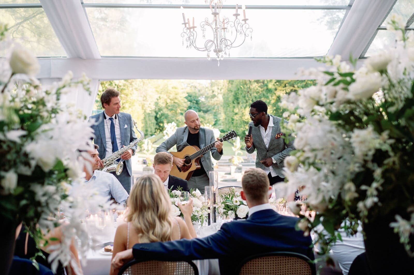 Bride and Groom Gets Serenaded Seated at Reception at Graydon Hall Manor Toronto Jacqueline James Photography
