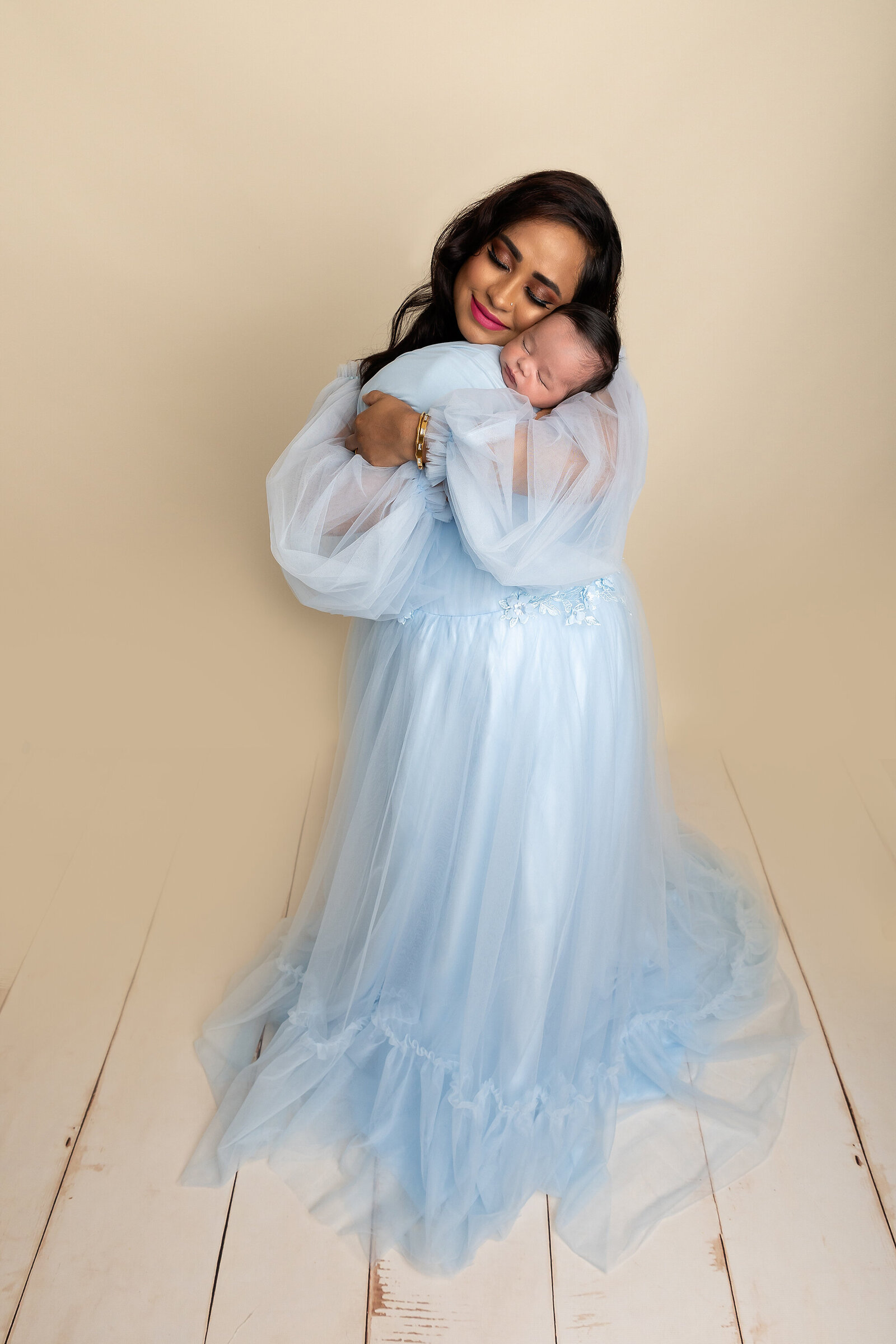 mom cuddling newborn boy by Newborn Photography Bucks County PA