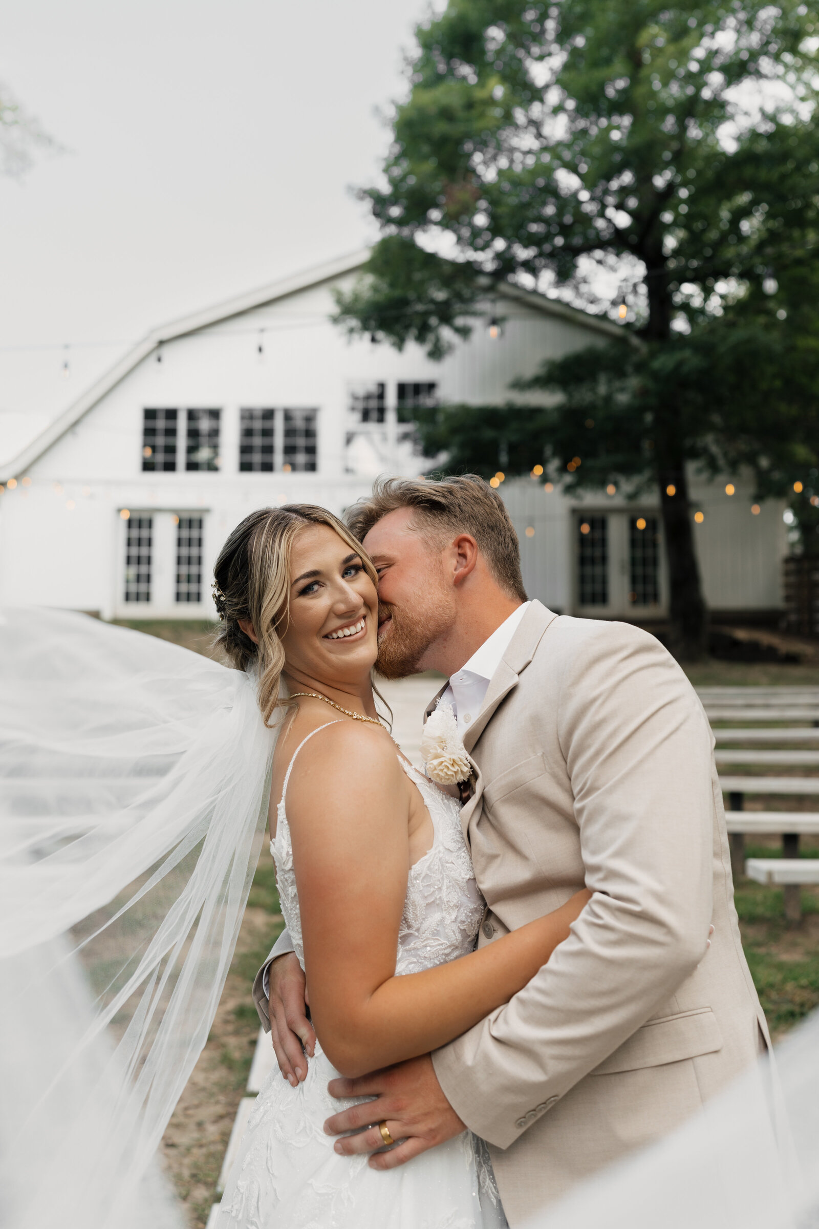 Bride and groom share a quiet moment in a beautifully lit outdoor setting, captured in a wedding portrait by Madelyn Price Photography.