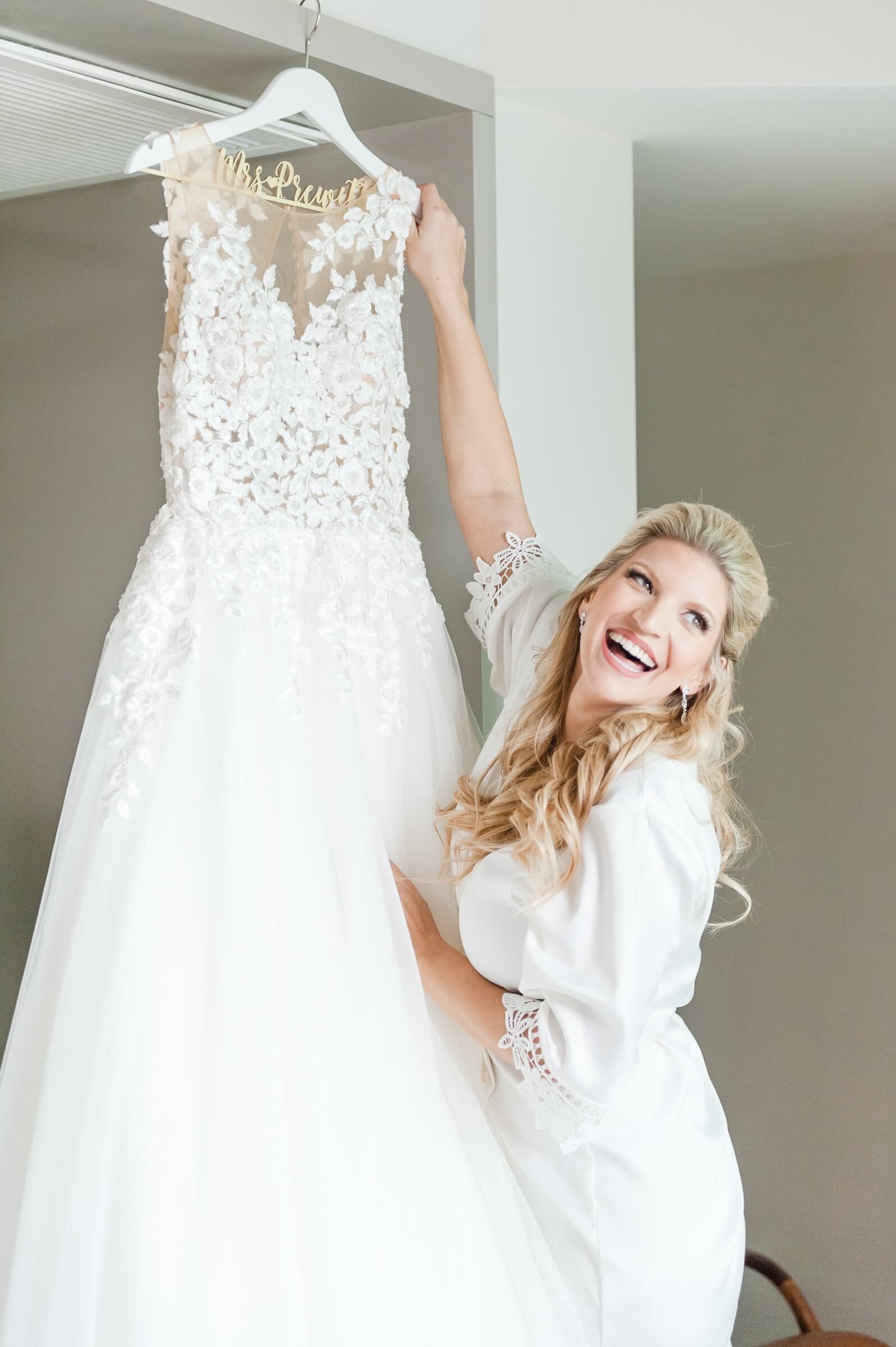 Bride laughing with bridal gown.