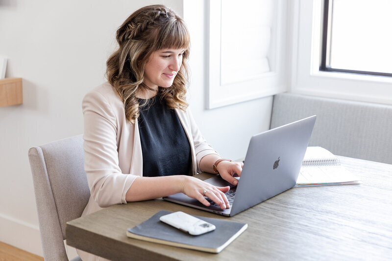 Heather-Leicy-Is-Typing-At-A-Computer-and-helping-other-photographers-understand-photography-business-taxes