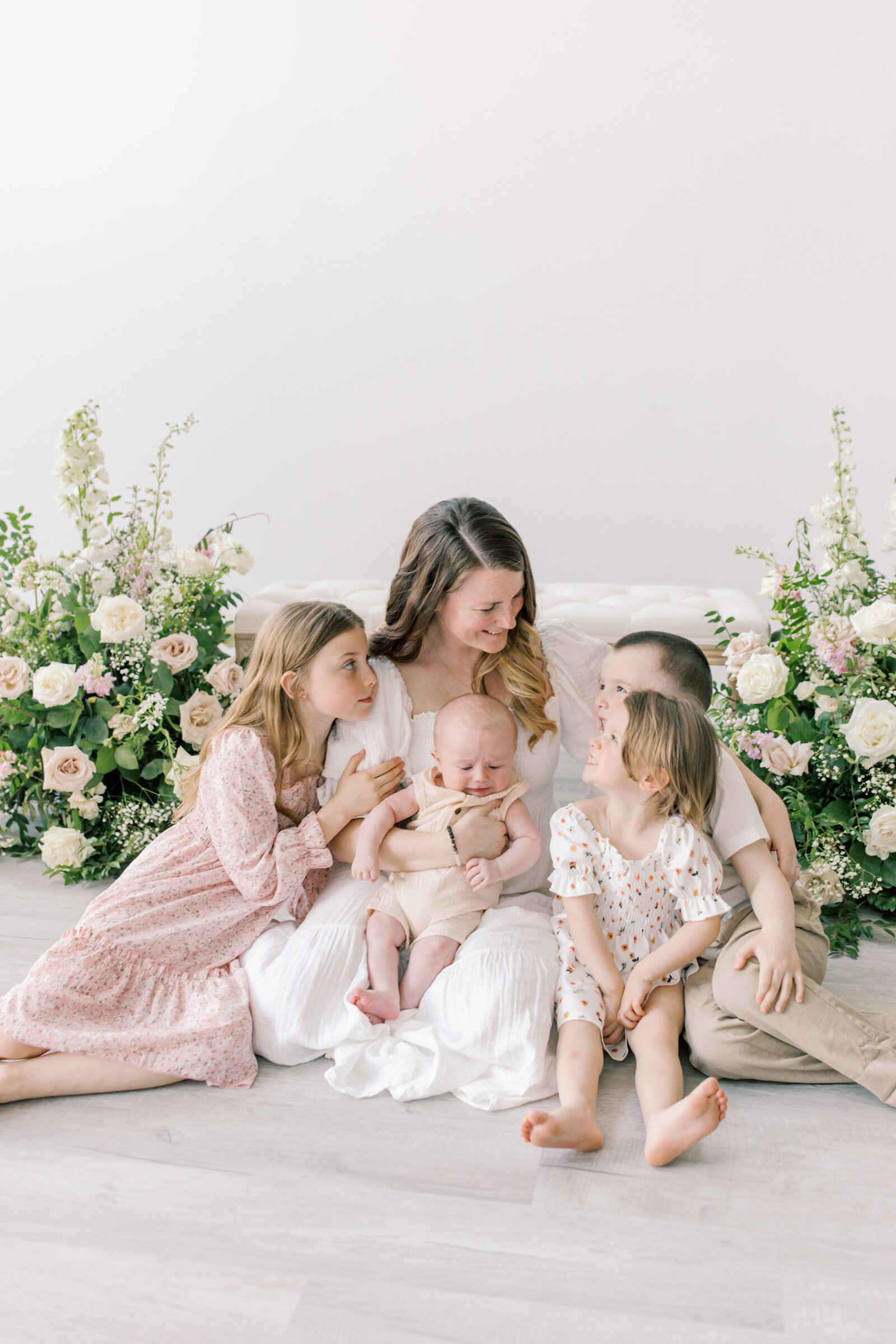 photo of mom with all her kids and a floral arrangement by spokane family photographer