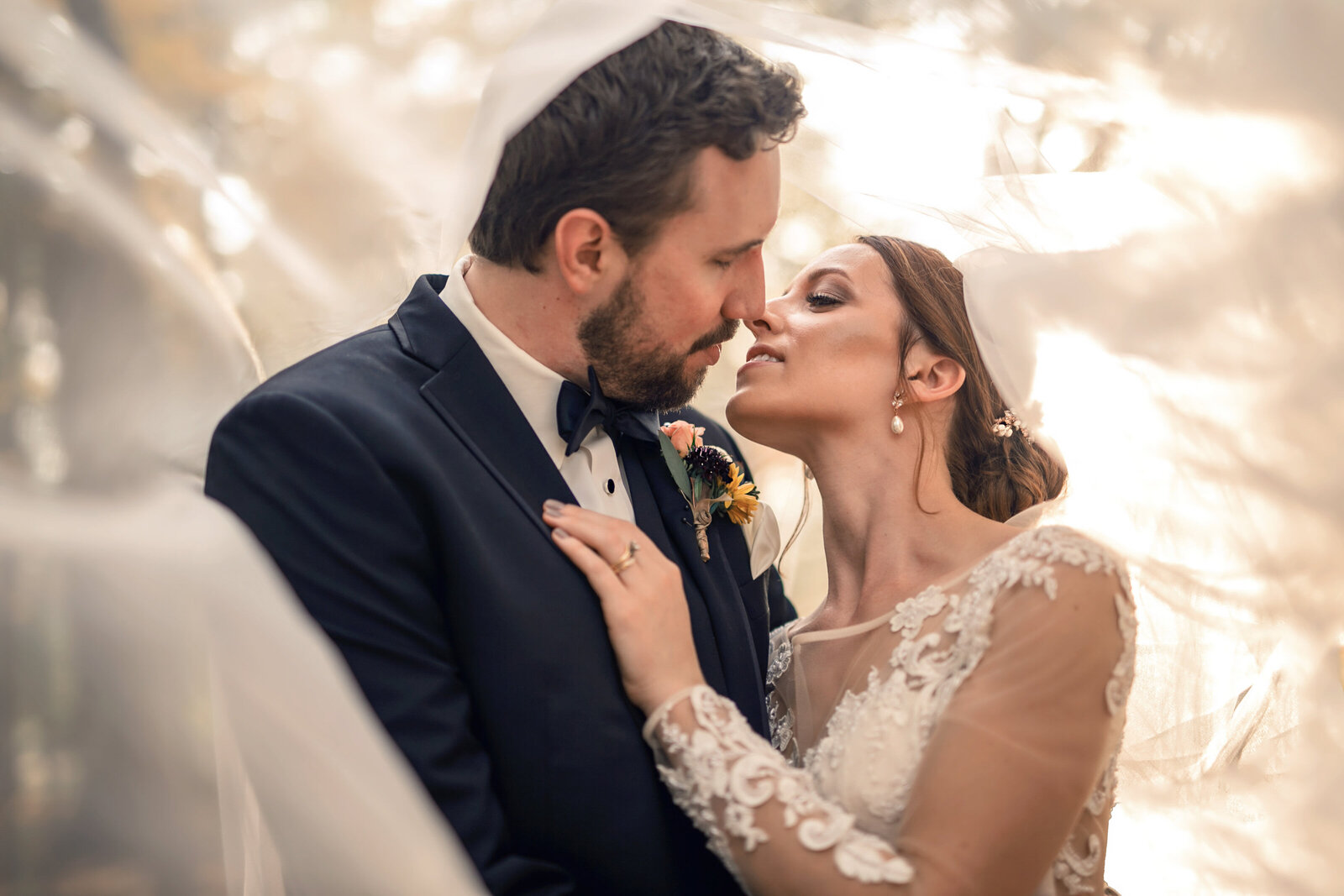 bride-and-groom-kiss-beneath-of-the-veil-for-a-wedding-photoshoot