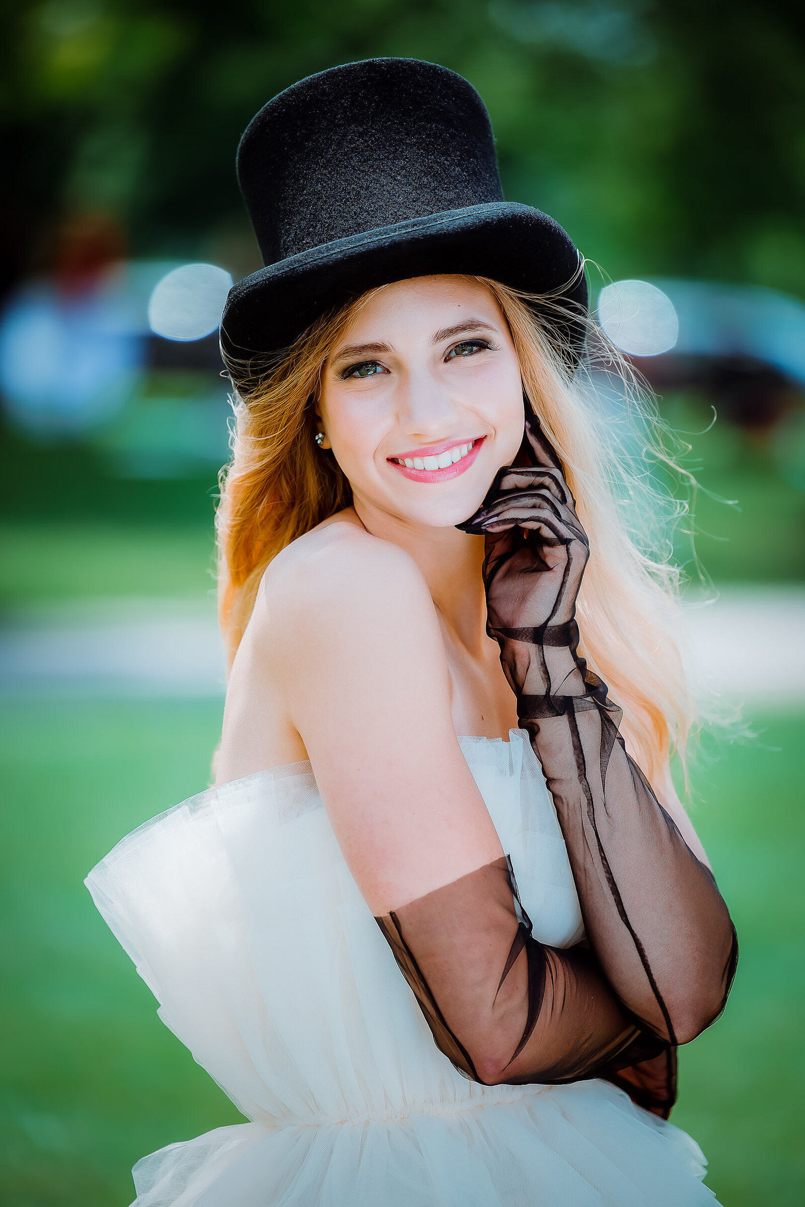 senior girl with black see through gloves and top hat