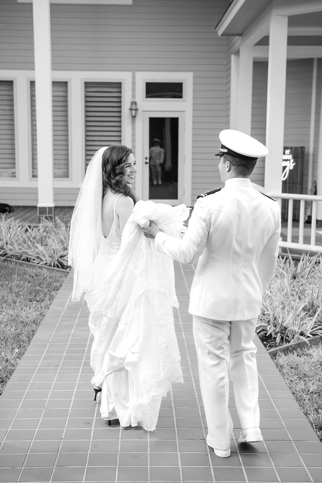 A candid shot of the bride and groom walking hand-in-hand after their wedding ceremony, captured by CMH Studios in San Antonio.