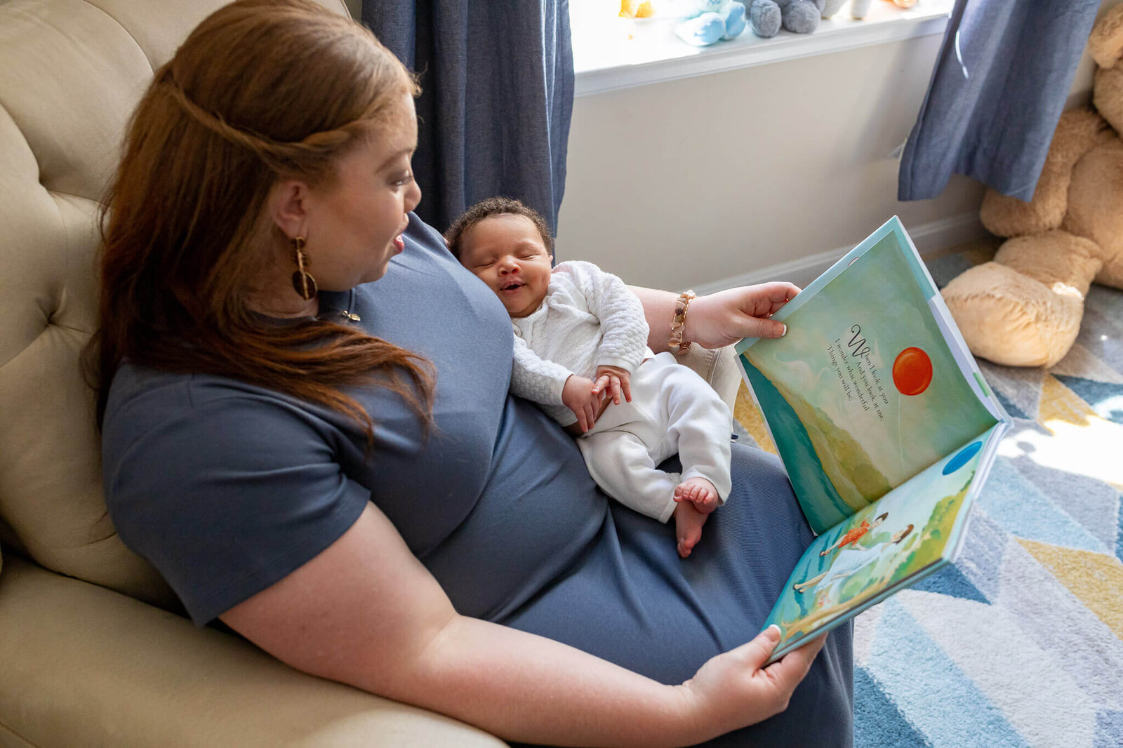 A Woodbridge  mom holding her newborn and reading him a book.