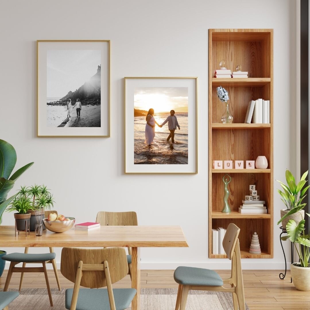 Two framed prints hanging on wall of dining area of parents expecting their first baby during a maternity session
