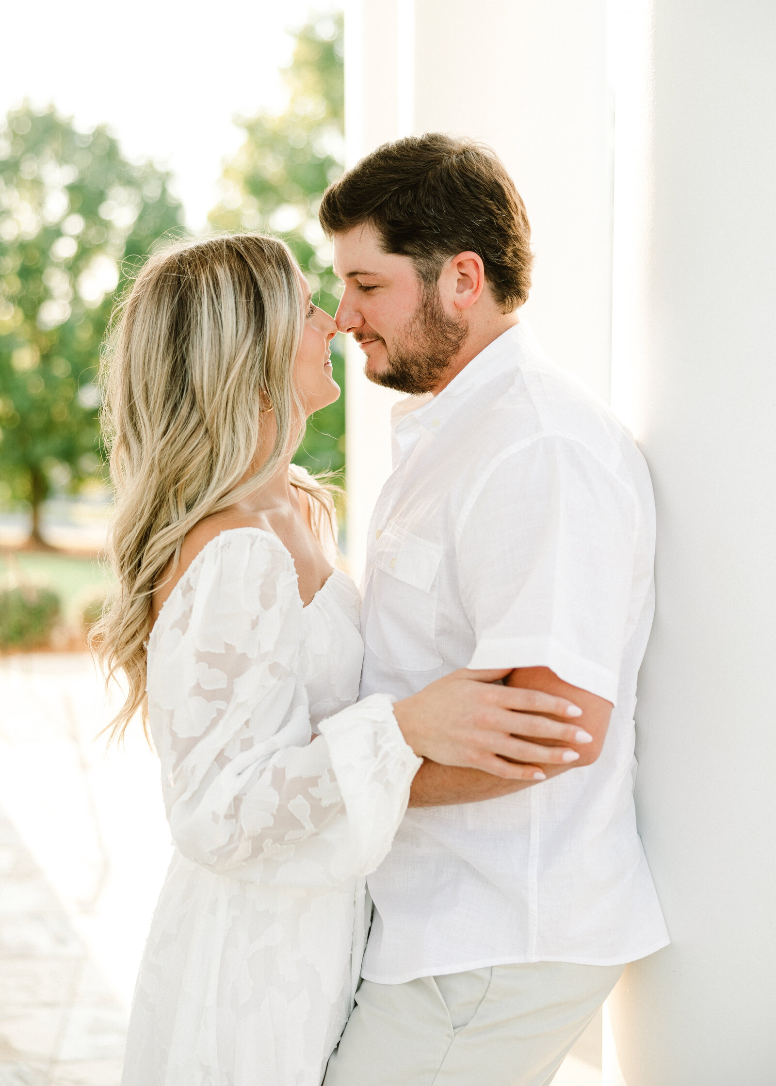 Close-up of Kelby and Mason touching noses, a romantic engagement shot by Abby Bell Photography. Fine art Alabama engagement photography.