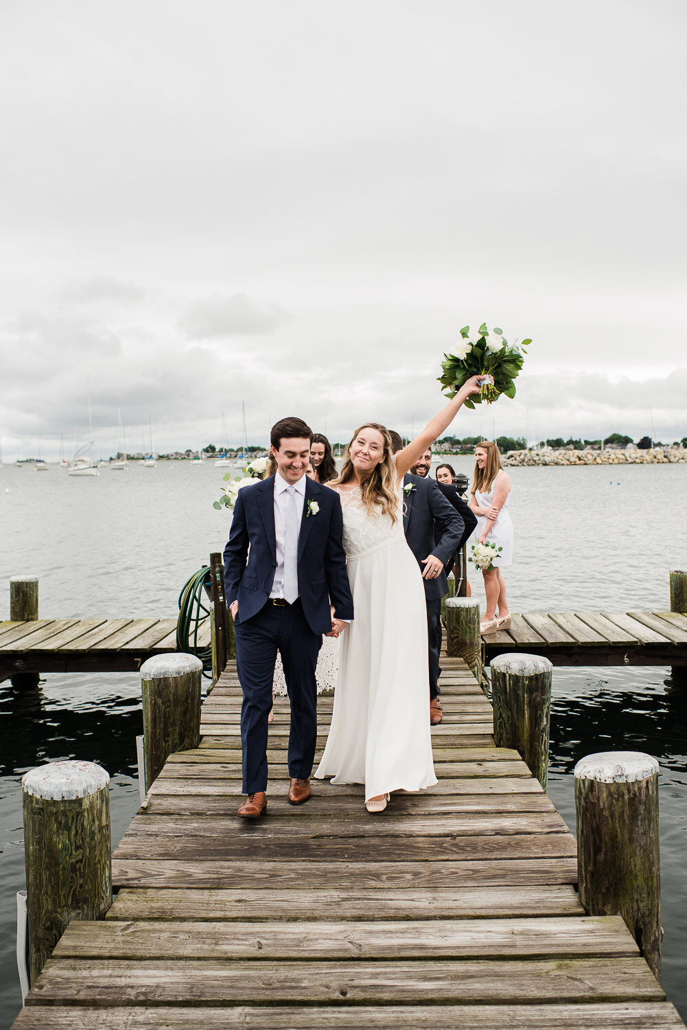 wedding party walking on dock