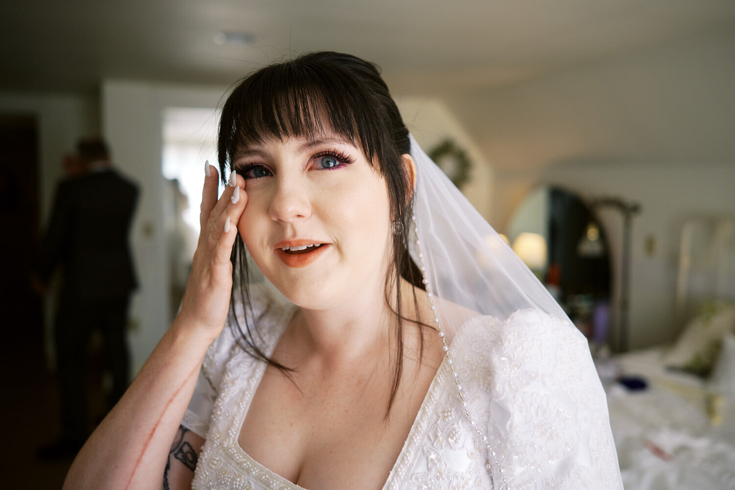 Bride wipes away a tear after seeing her dad