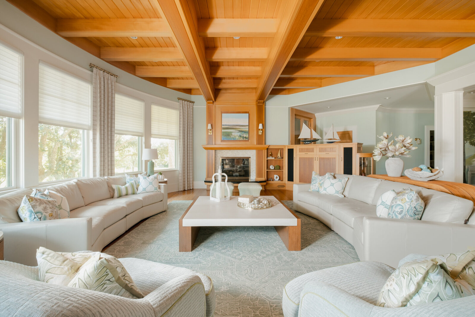 Living room remodel of a coastal home in Wilmington, NC, featuring serene, watery colors, updated flooring, and large windows framing stunning Intracoastal Waterway views."