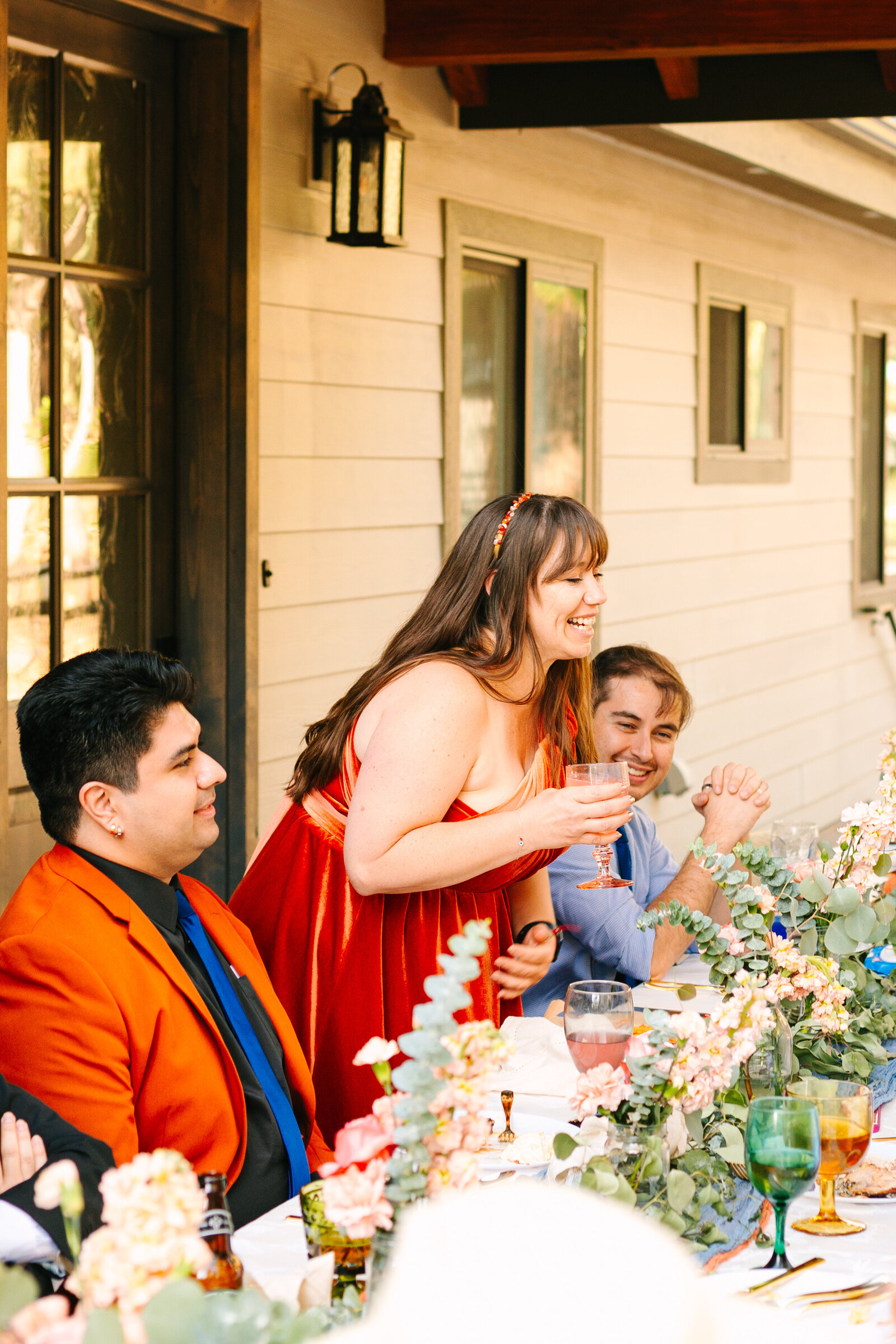 The bridal party celebrates an intimate elopement at a cabin at Big Bear Lake, California.