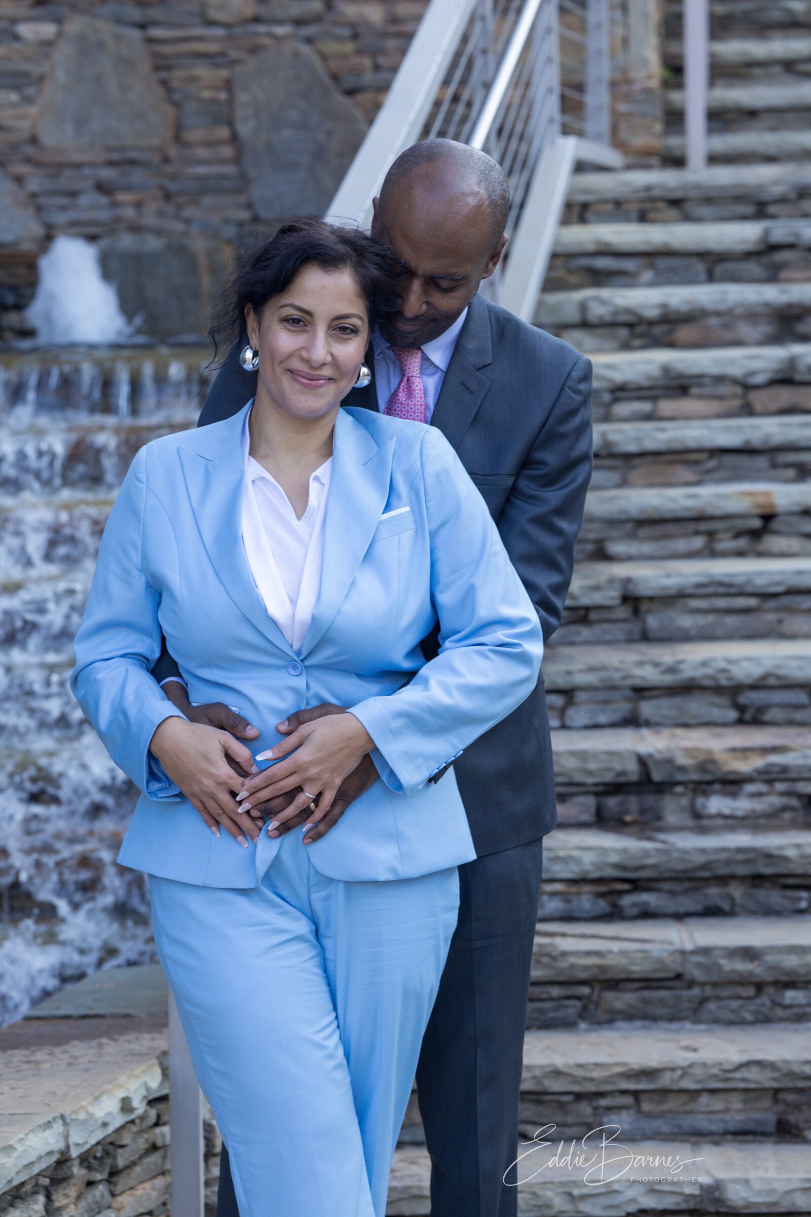 Husband leaning on his wife near steps