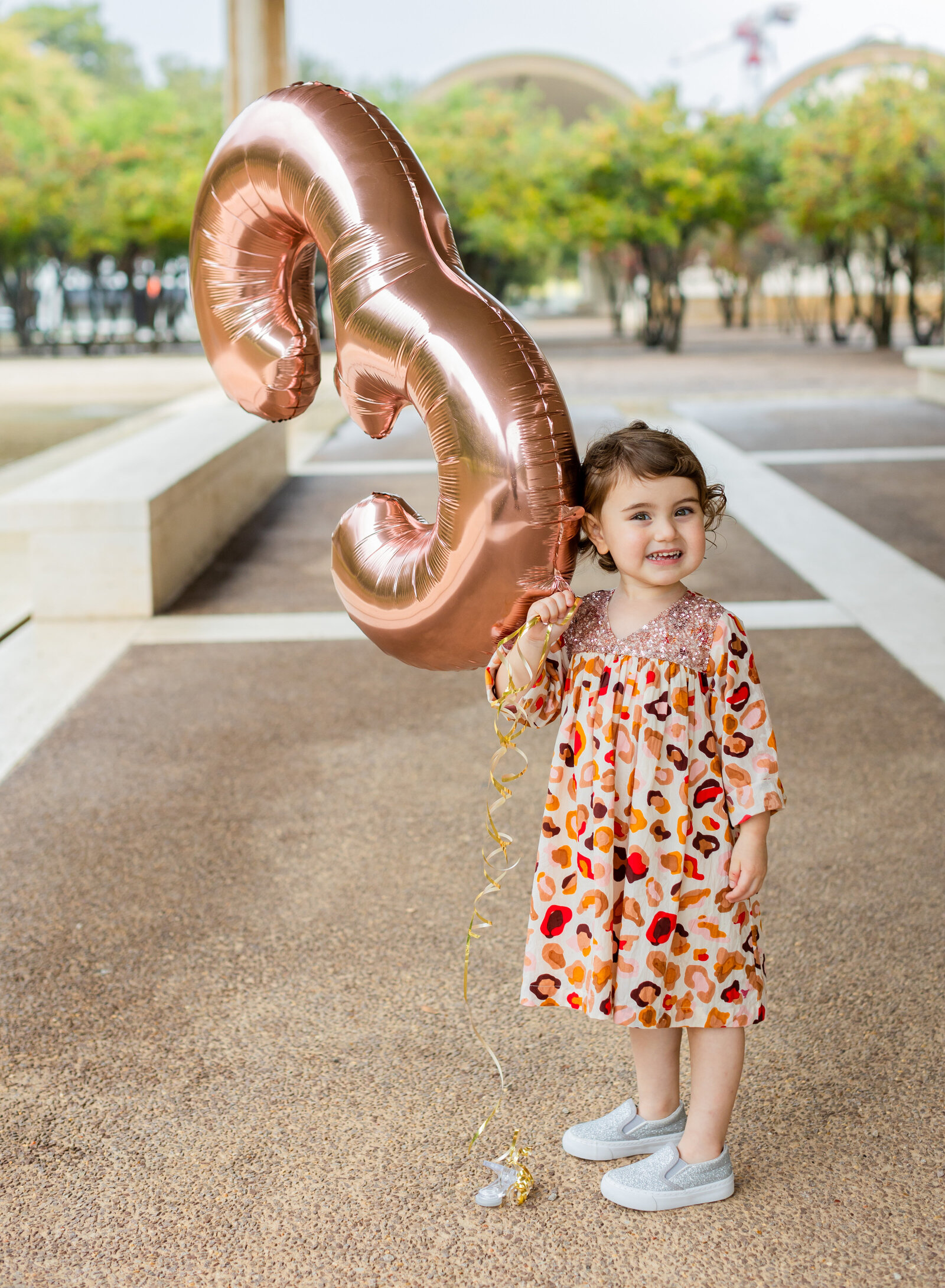 three year old with birthday balloon