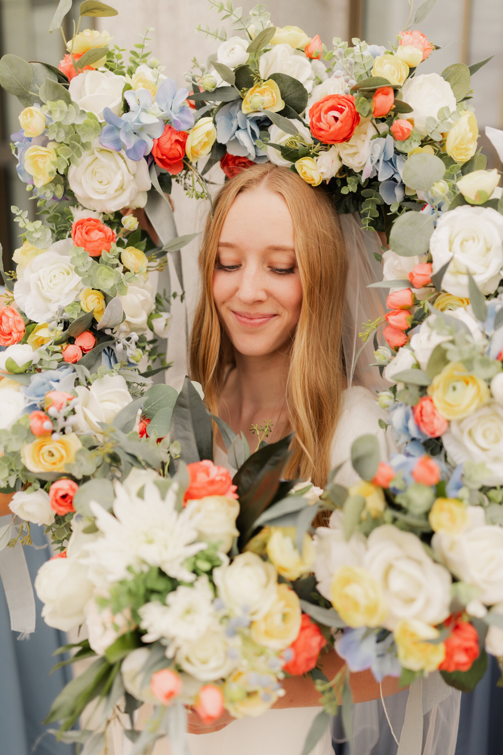 bride smiles with her bouquet at the Draper Temple Wedding, photo taken by Logan Utah Wedding Photographer