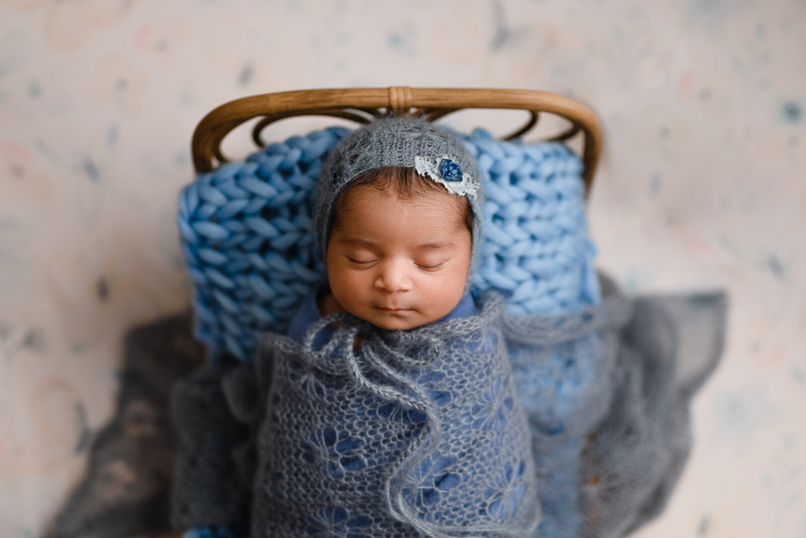 Newborn girl in blue beautiful bonnet