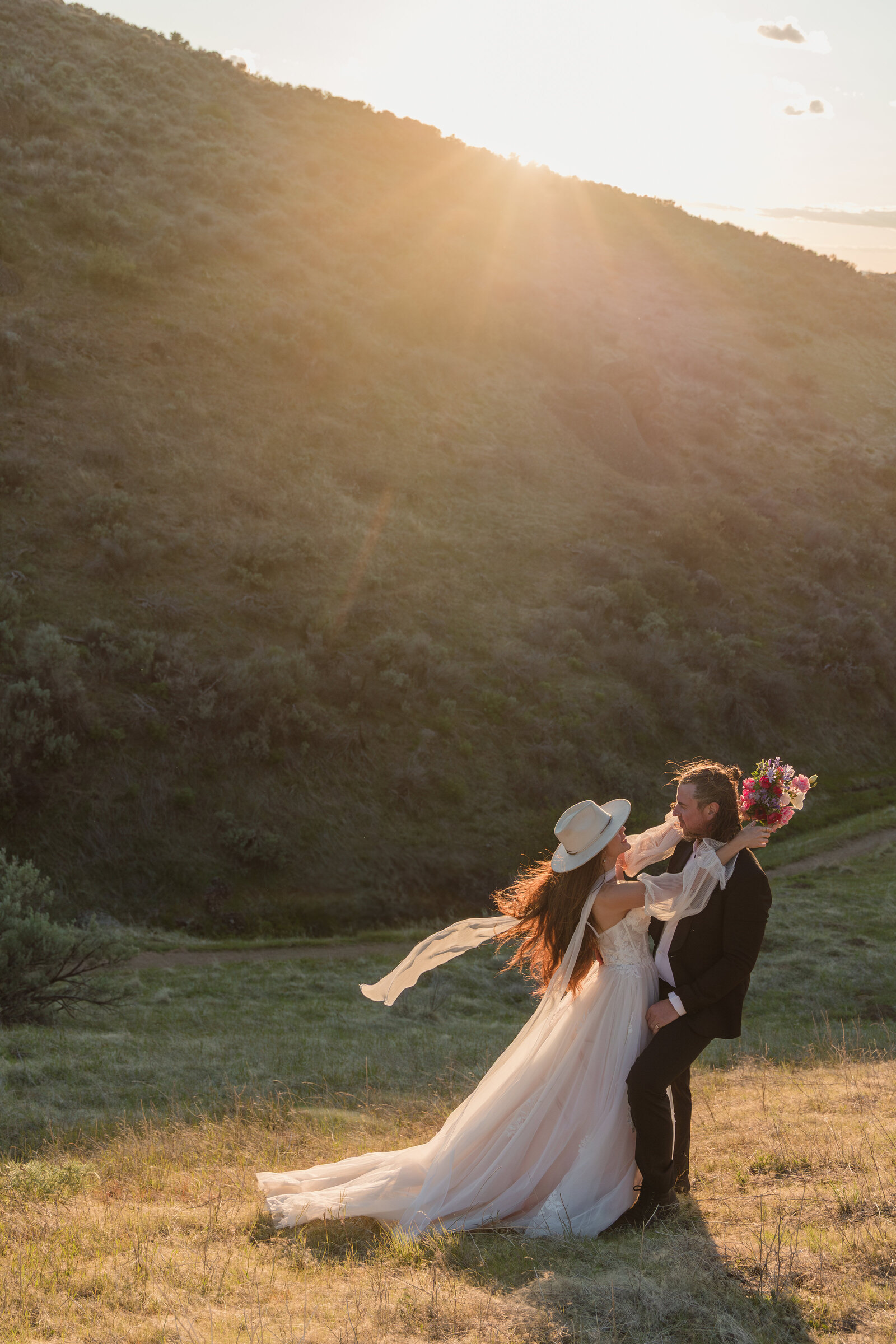 A gorgeous couple embracing each other at golden hour in the Boise Idaho foothills for their wedding